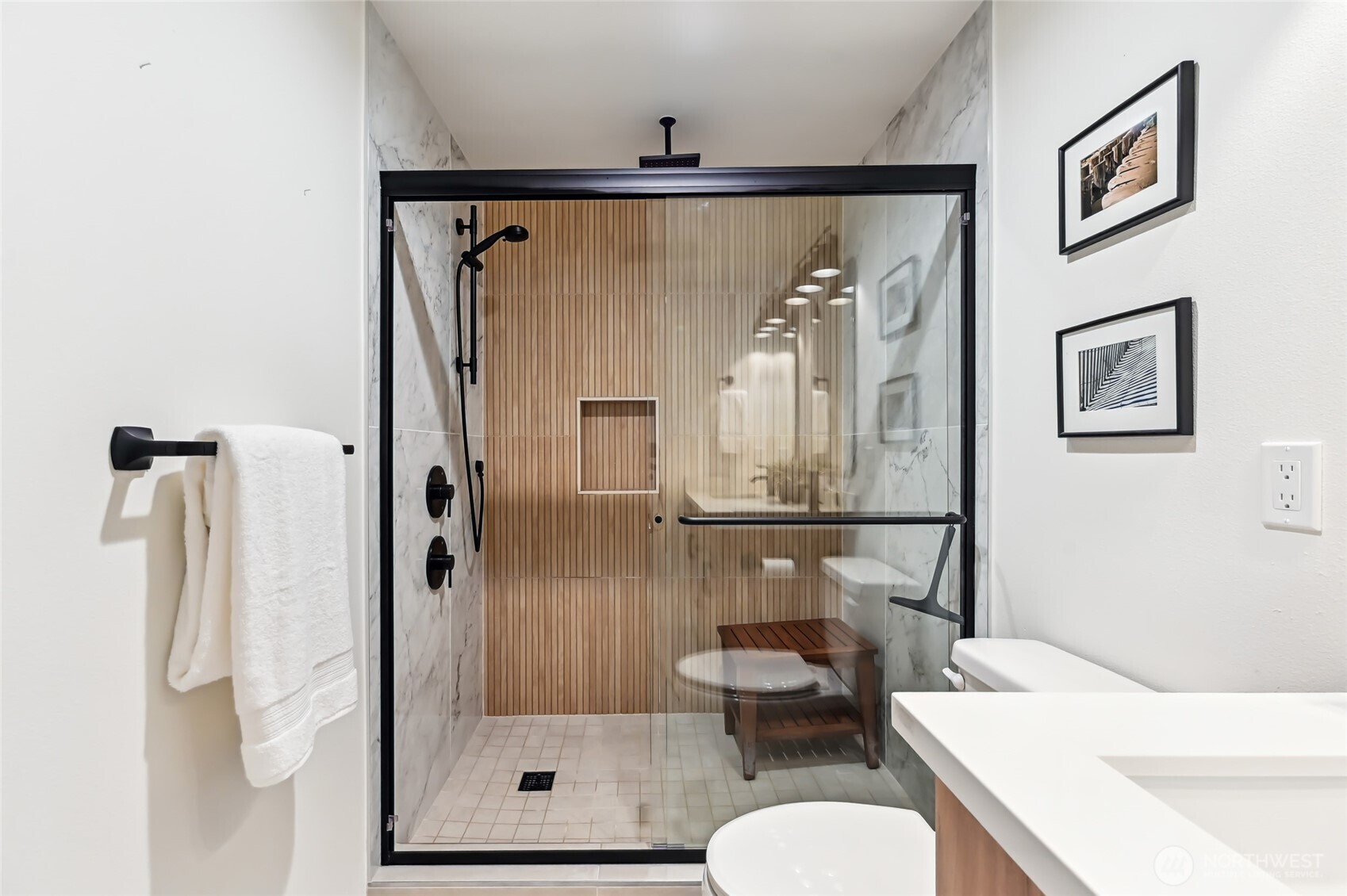 Huge primary shower is ideal! Wood accents showcase the thought to detail in the home.