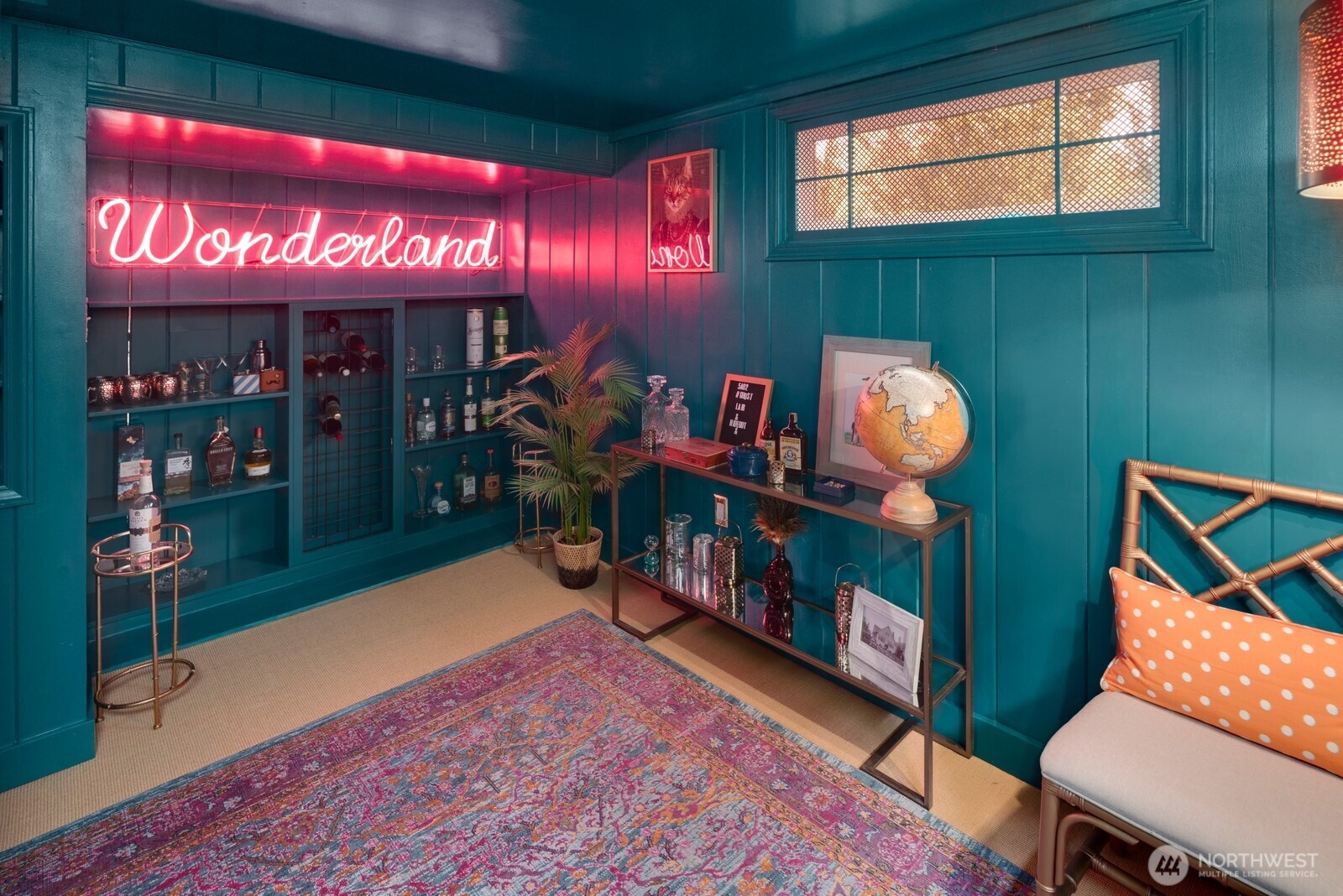 Hidden speakeasy-style room tucked behind custom built-ins—a perfect space for entertaining or relaxing in style.