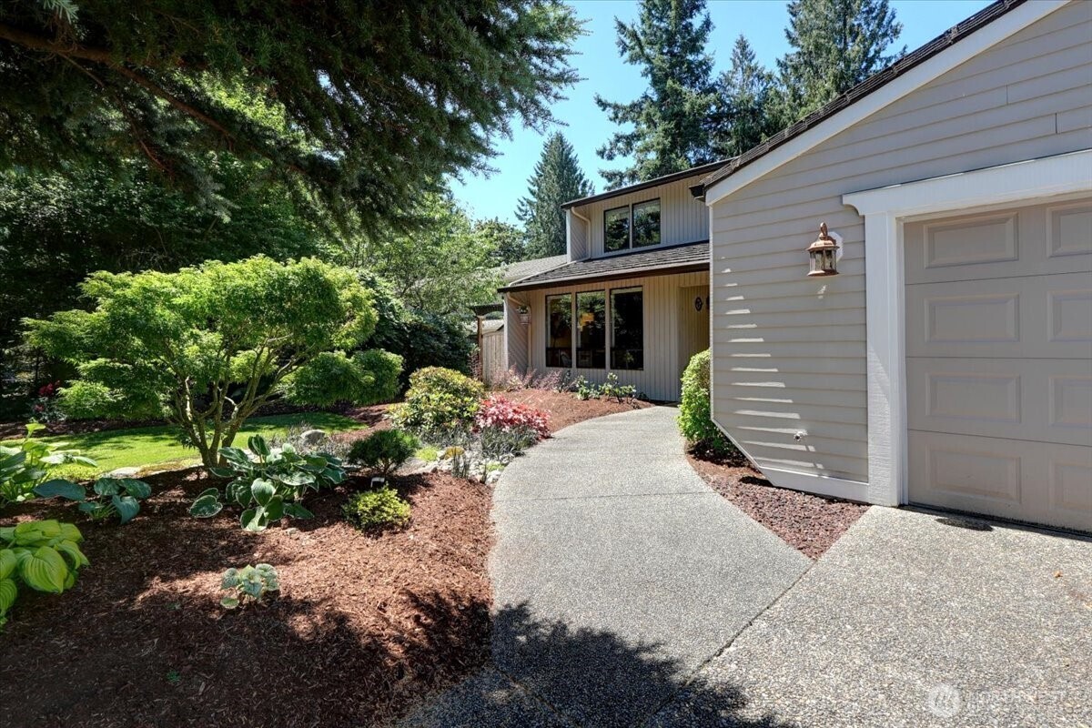 Beautiful inviting entrance - not the wide sidewalk and oversized garage.