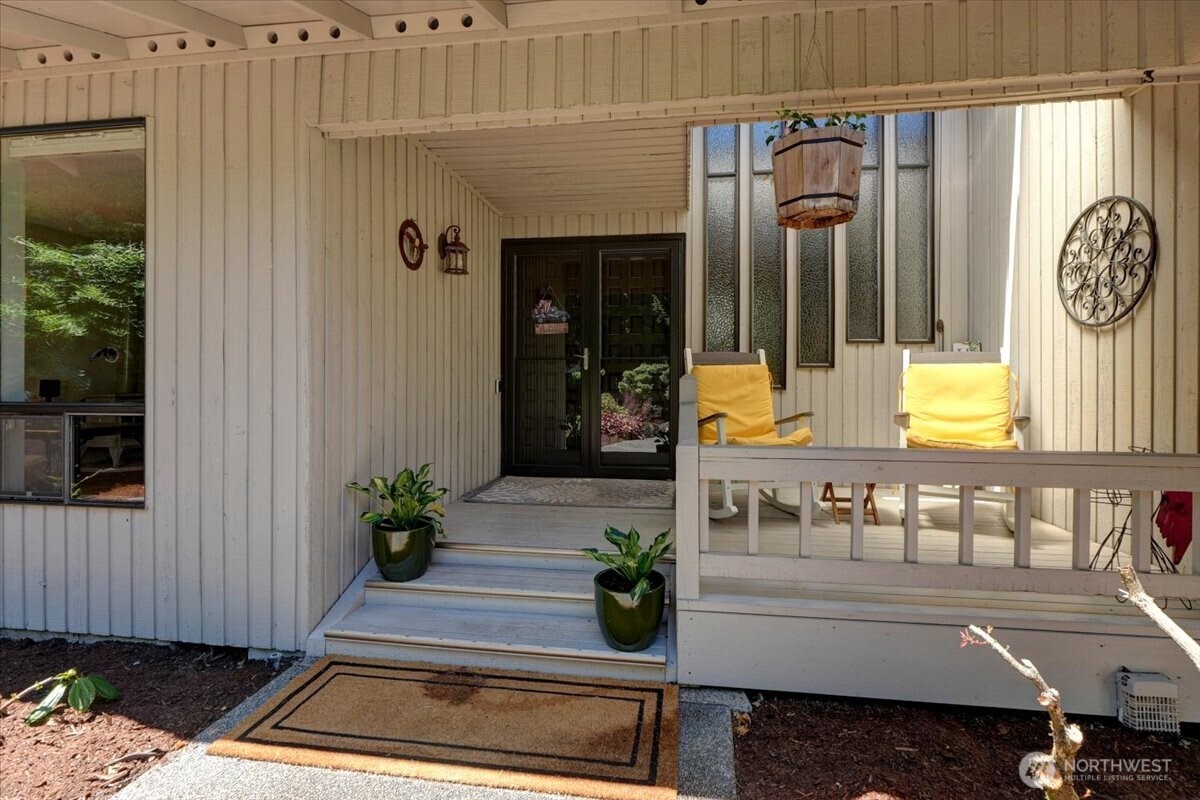 Inviting covered front porch with double door entry.