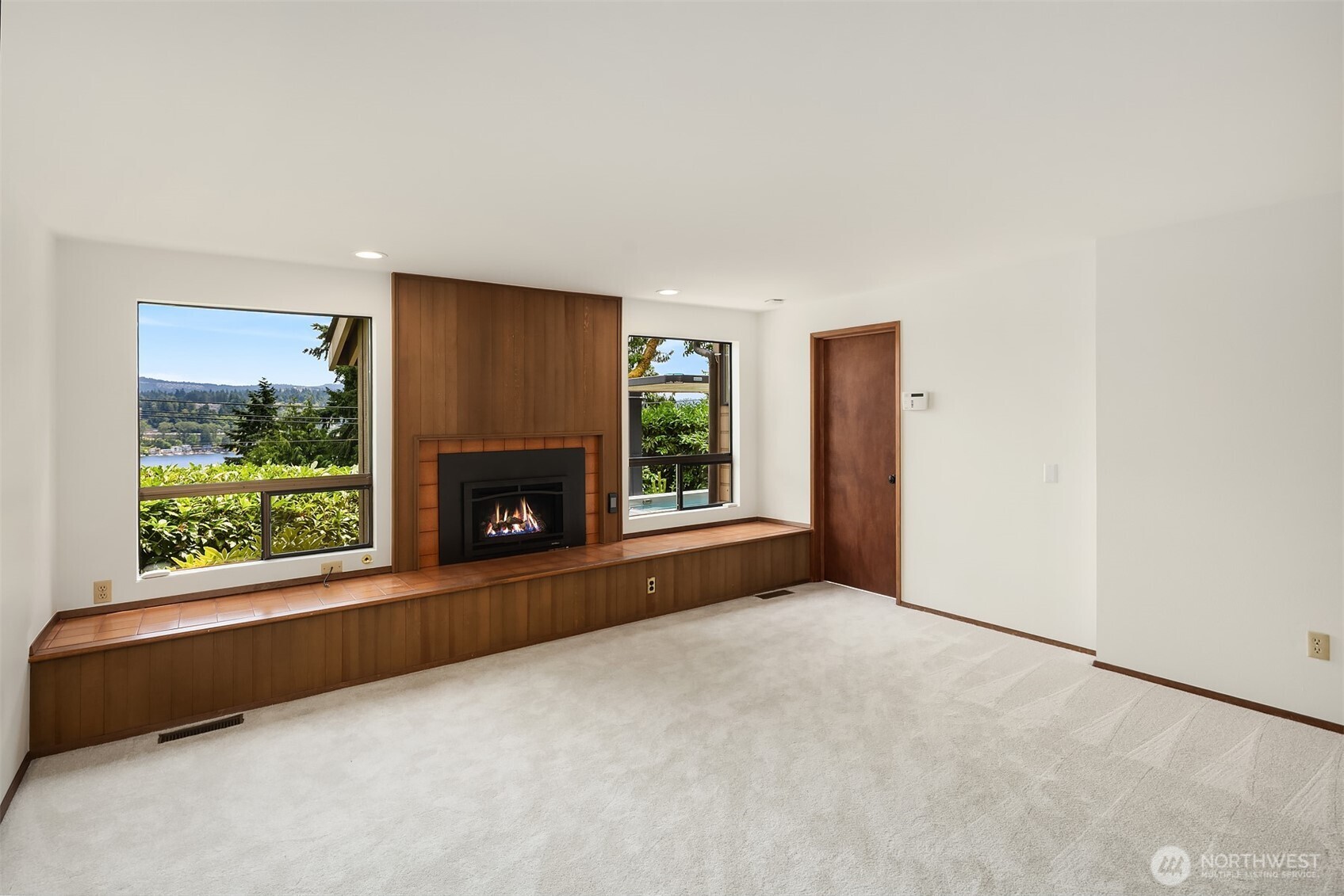 Spacious rec room with fireplace. Out of frame is a handy built-in desk/storage space.