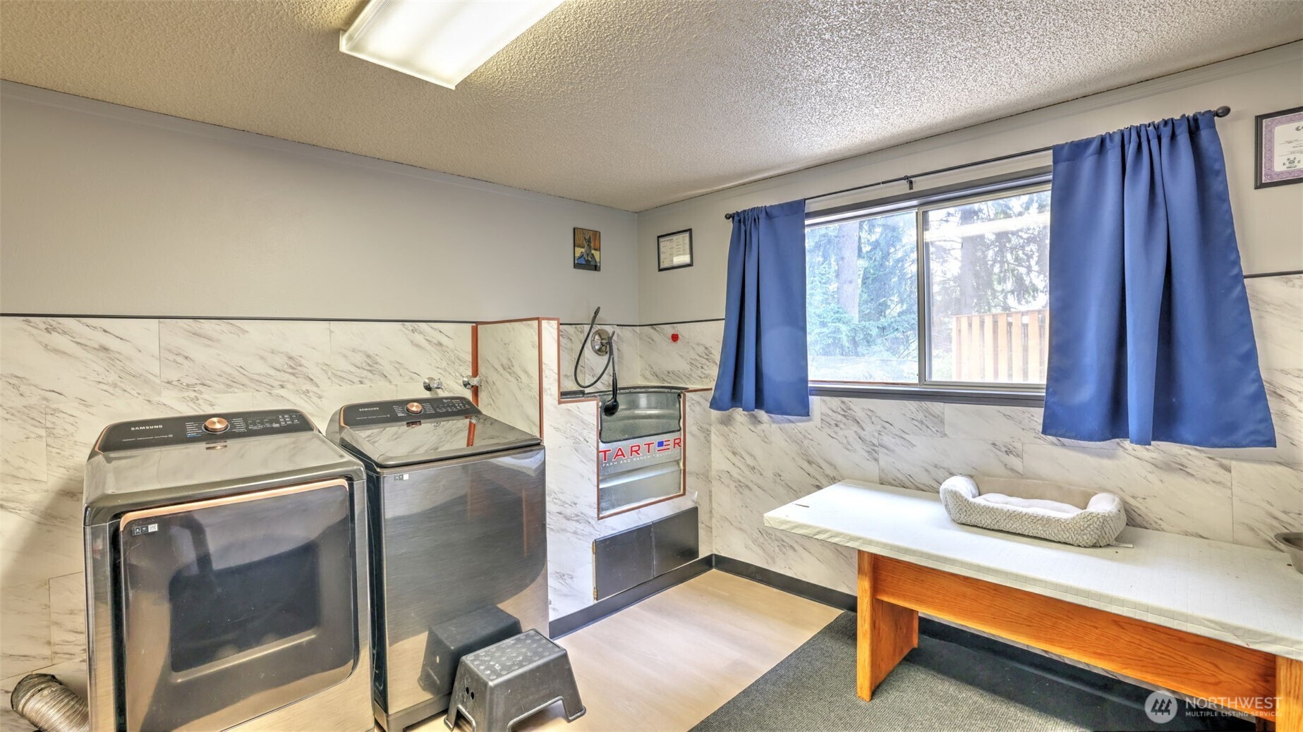 Huge Laundry room which has a dog wash and a closet for additional storage.