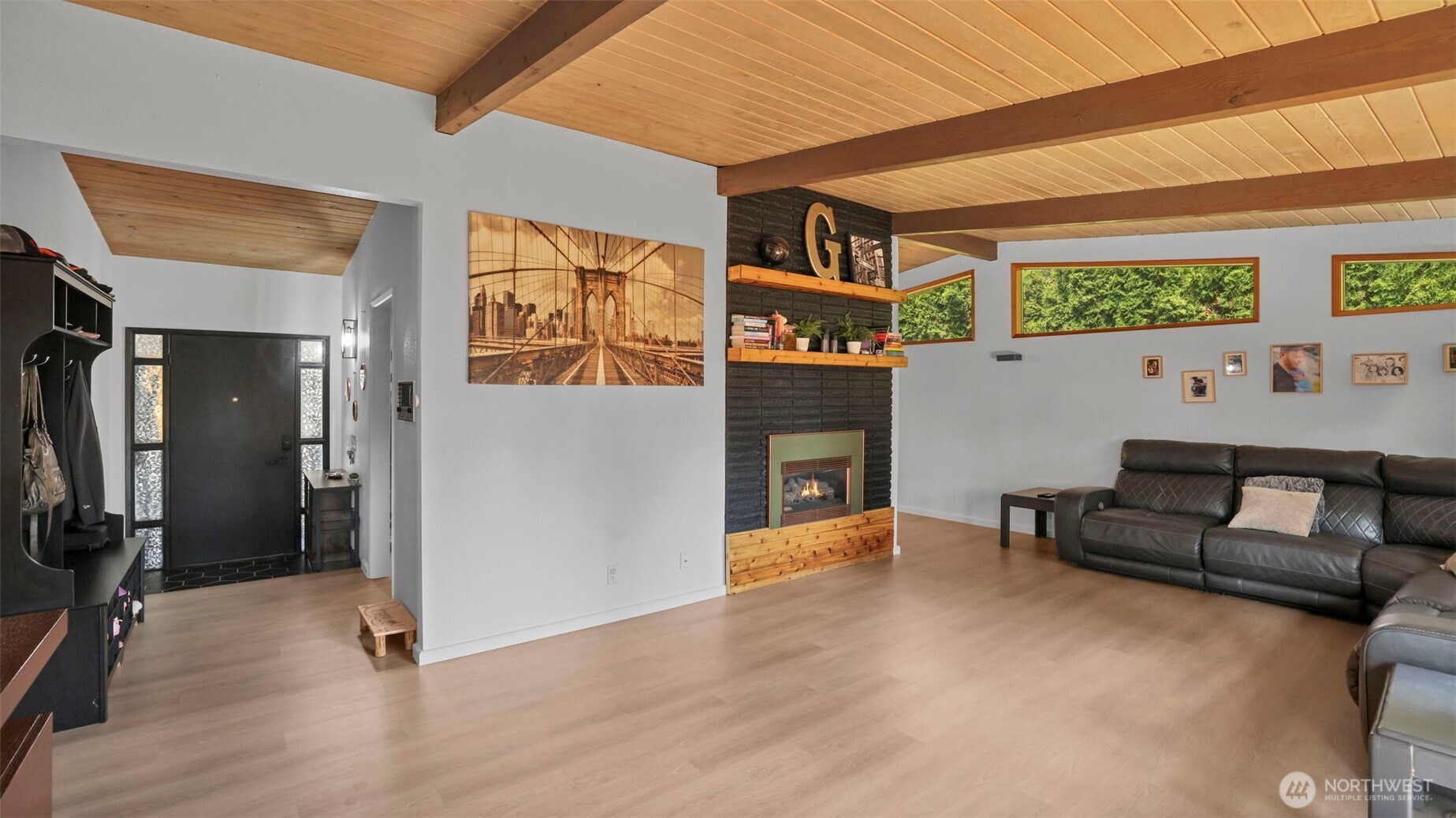 Douglas fir ceilings with exposed beams throughout the main floor. Gas fireplace in living room.