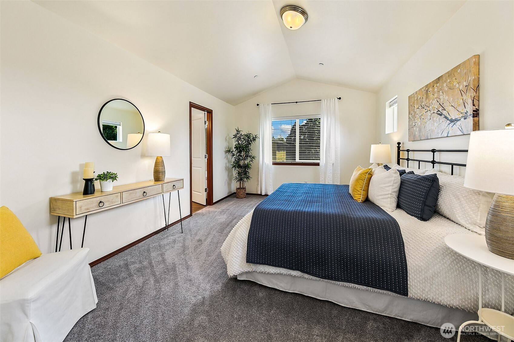 Primary bedroom with vaulted ceilings