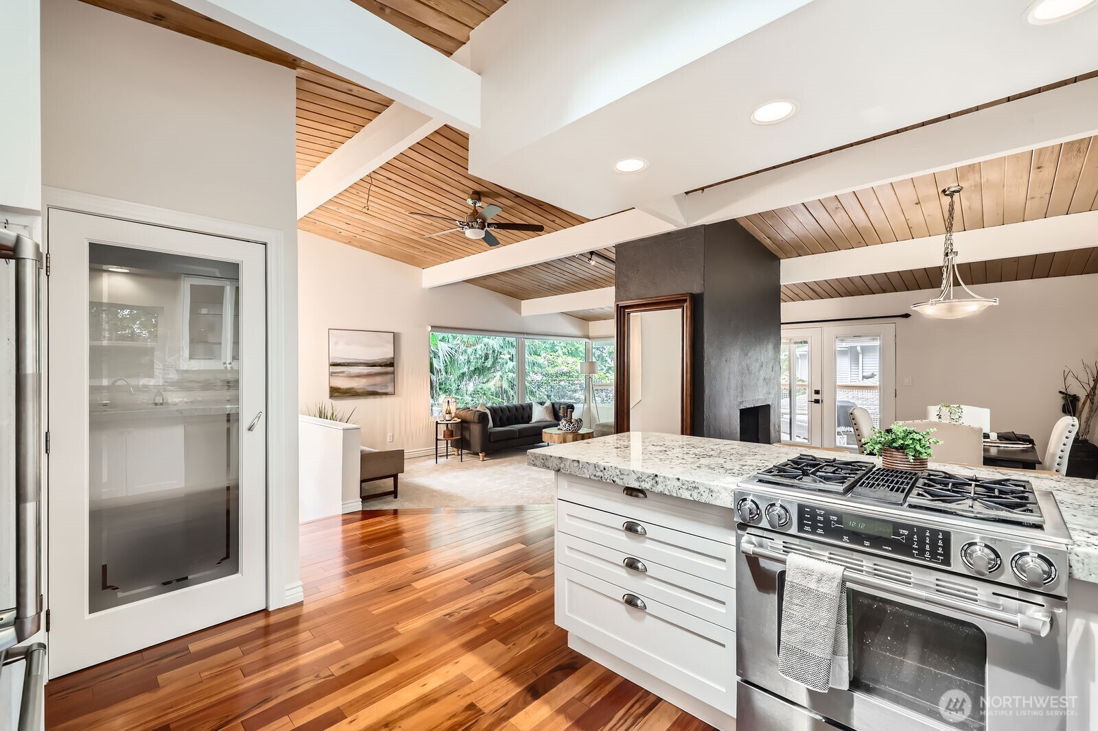 The kitchen pantry offers abundant storage. Slab granite countertops are functional and elegant.