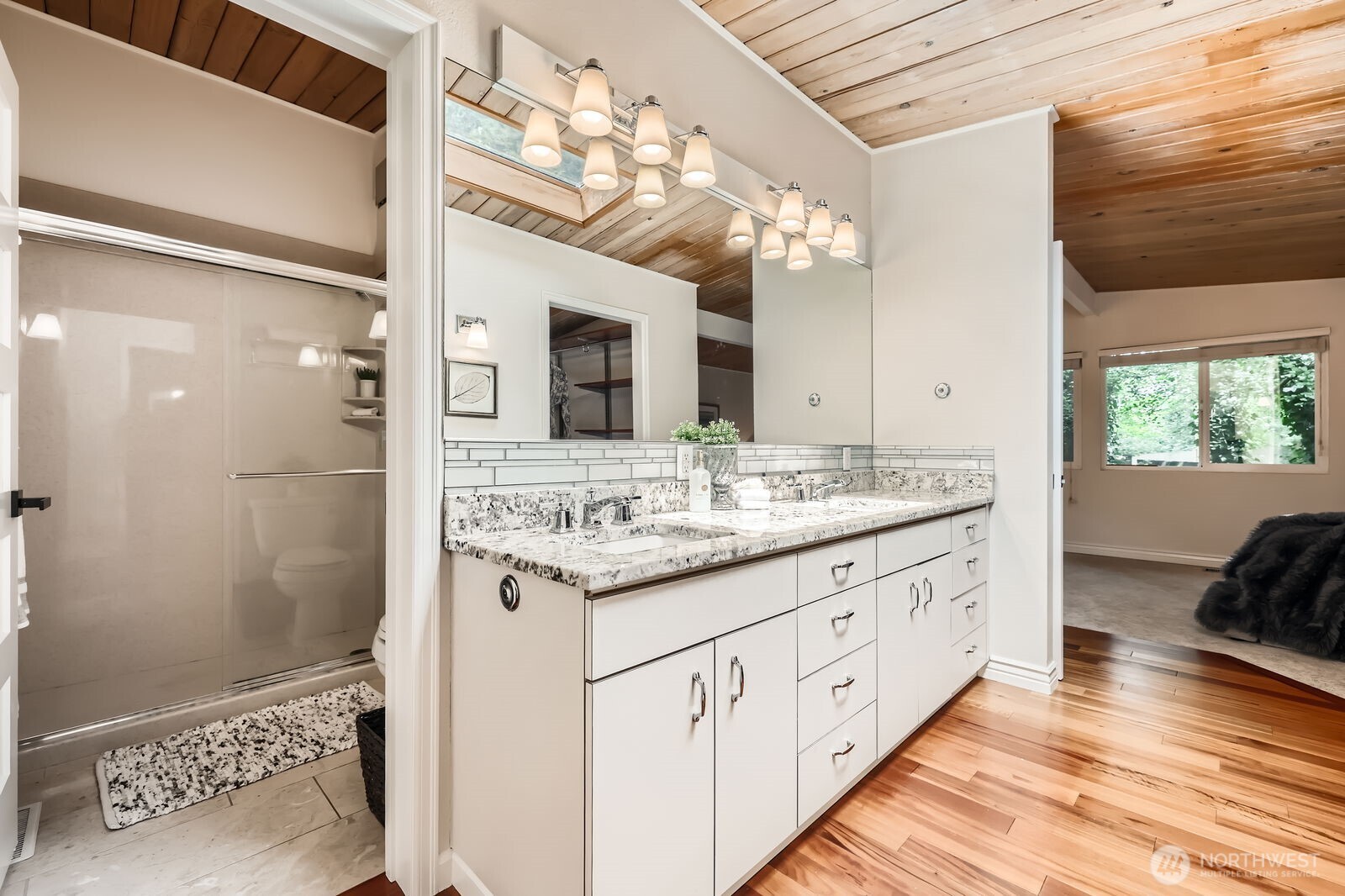 The primary bathroom has a double sink vanity with generous storage and a large shower