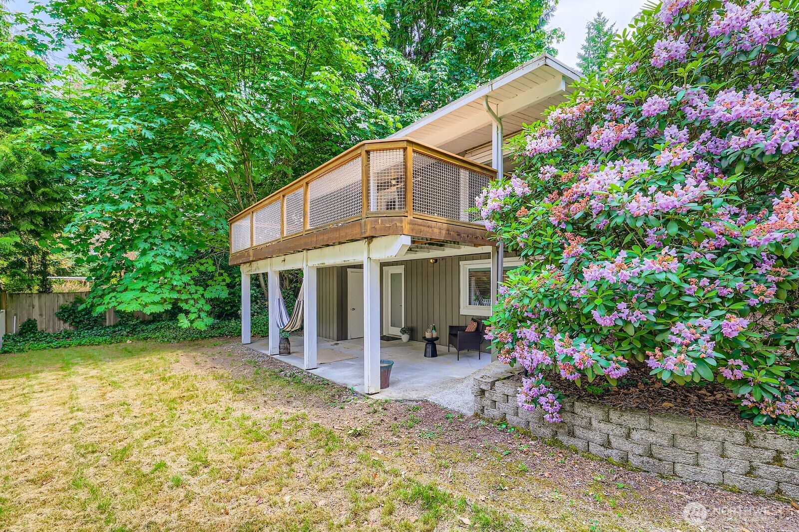 The lower level has its own private entrance and patio facing the yard.
