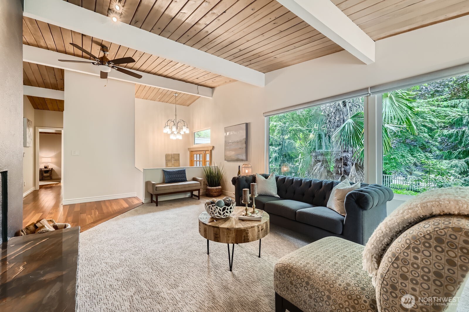The large wraparound windows bathe the living room in natural light