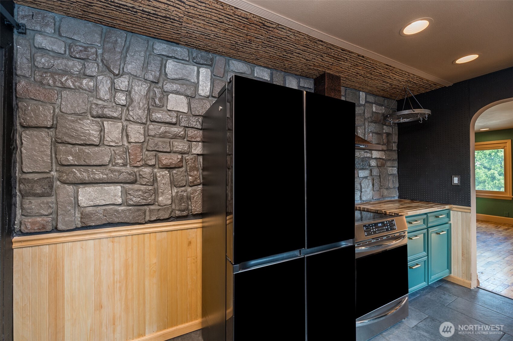 $ panel black stainless fridge and Tile flooring.