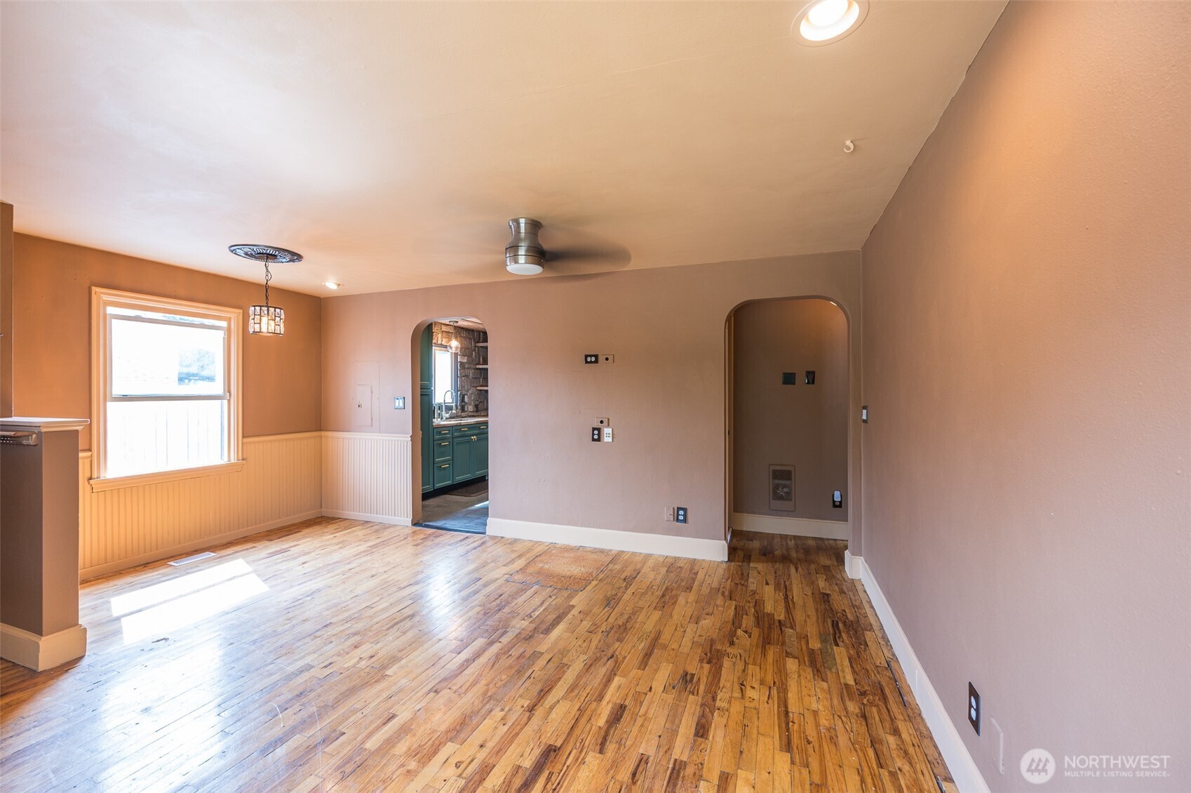 Charm for days with the rounded doorways and wainscoting.