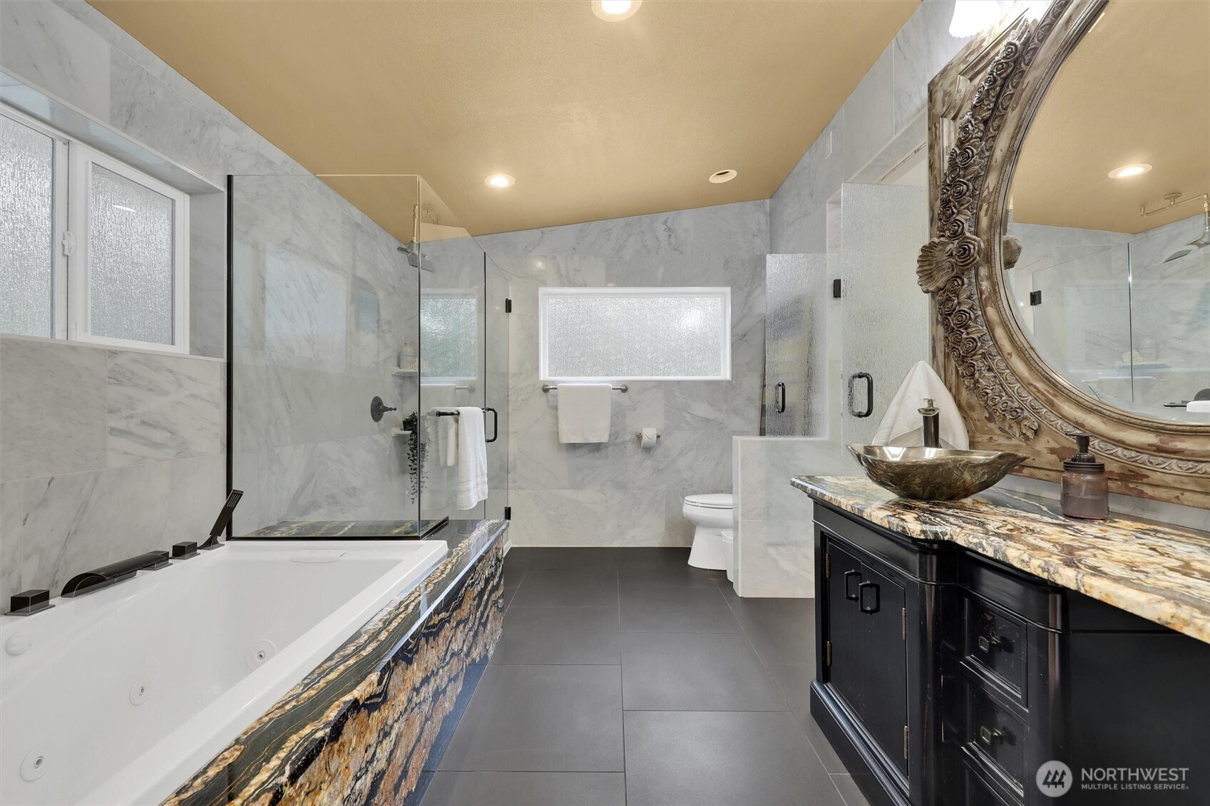 Freshly updated primary bathroom with modern finishes and a soothing spa-like feel.