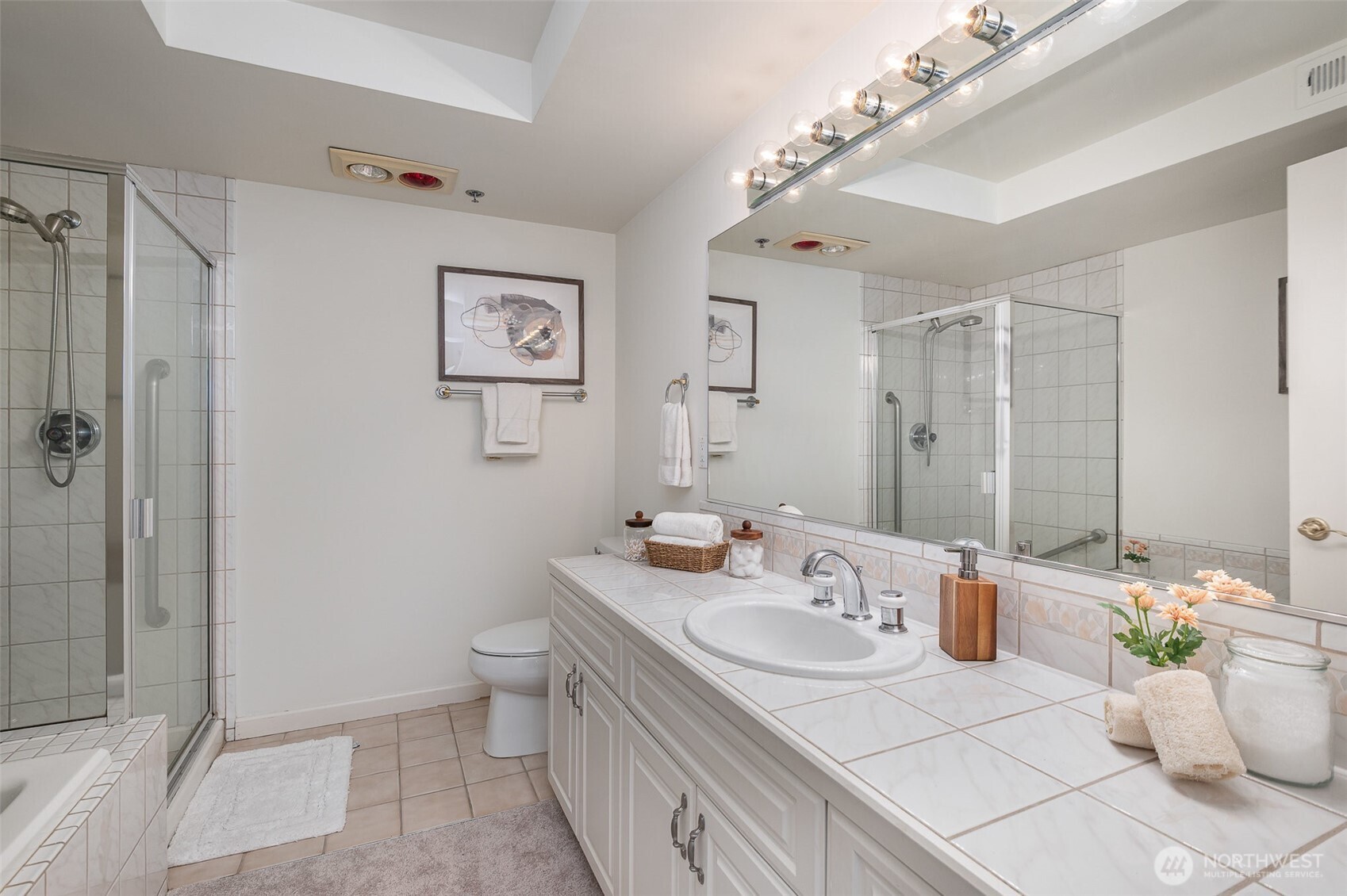 The 5-piece ensuite bath offers ample counter space, and a generously sized glass-enclosed shower for a spa-like experience.