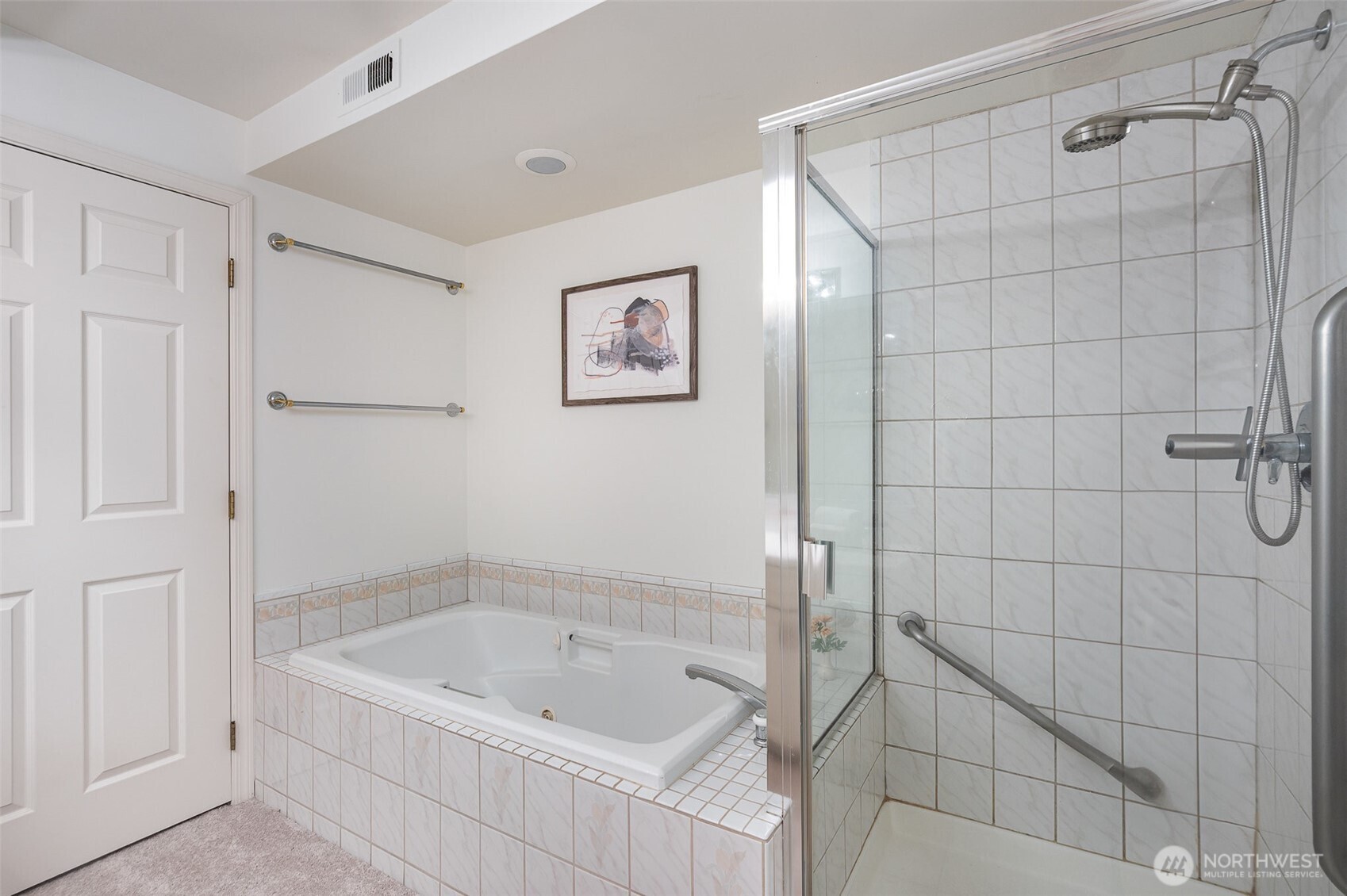 Relax in the large jetted soaking tub or step into the walk-in shower—this thoughtfully designed bathroom provides both comfort and convenience.