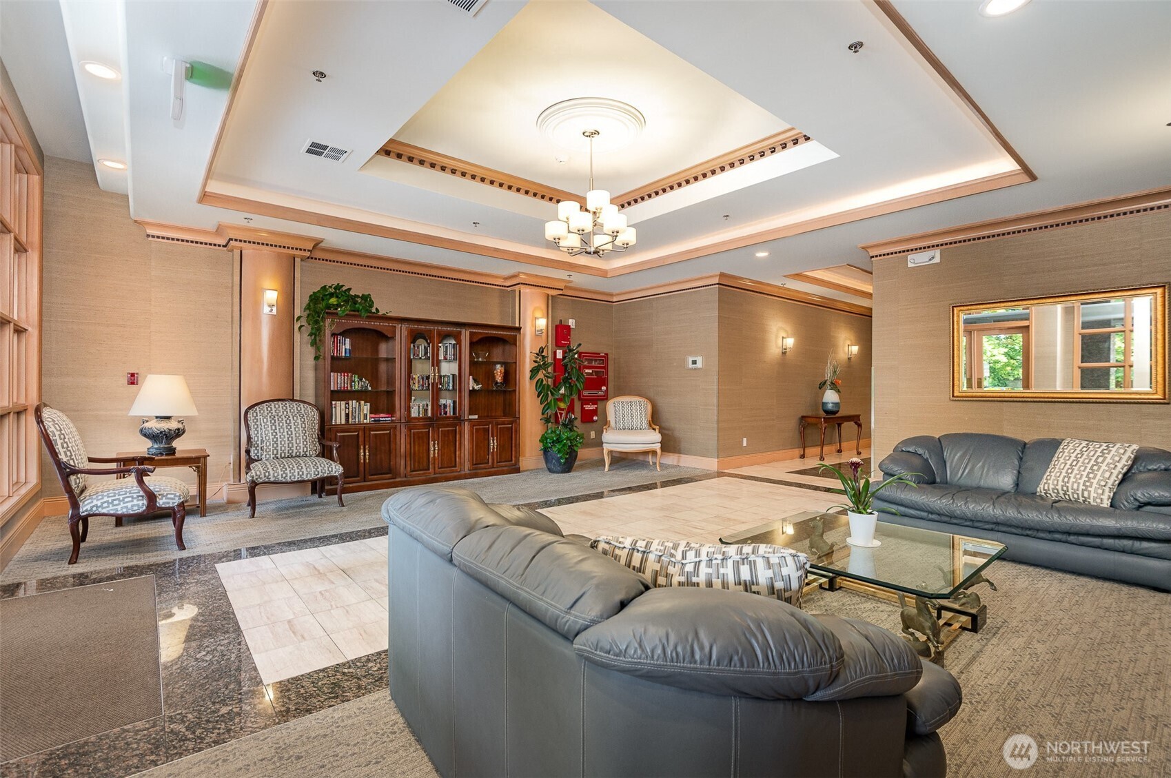 Step into the inviting ParkPlace lobby—an elegant lounge space featuring warm wood accents, a cozy library nook, and comfortable seating designed to make every arrival feel like home.