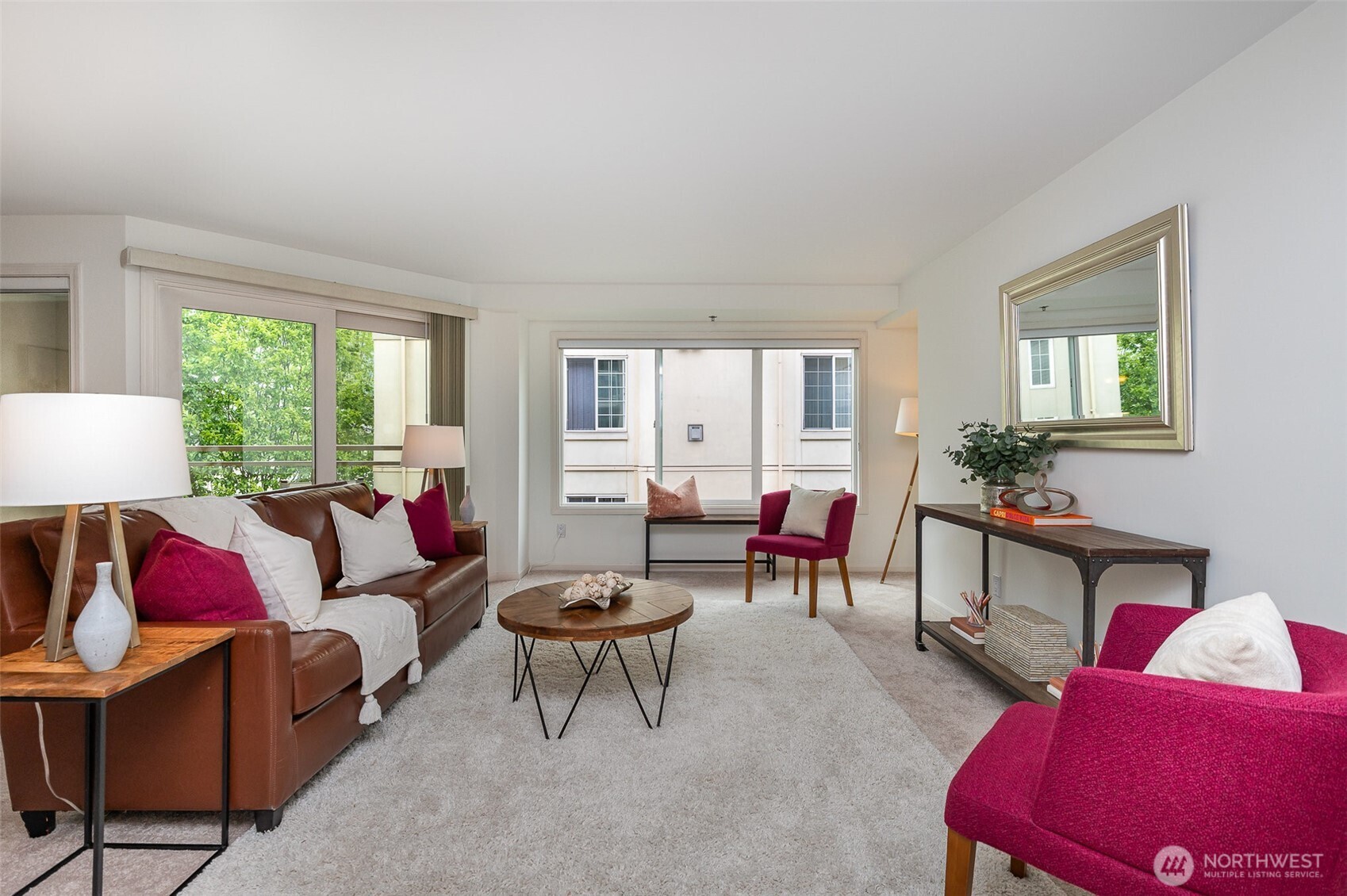 The light-filled living area showcases oversized windows, creating a bright and sophisticated space that’s ideal for both relaxing and entertaining.