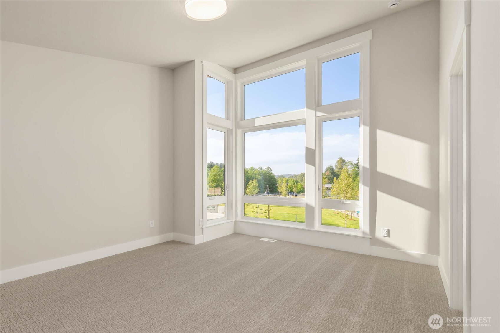 One of 3 spacious secondary bedrooms upstairs with vaulted ceilings and walk in closet with custom solid shelving