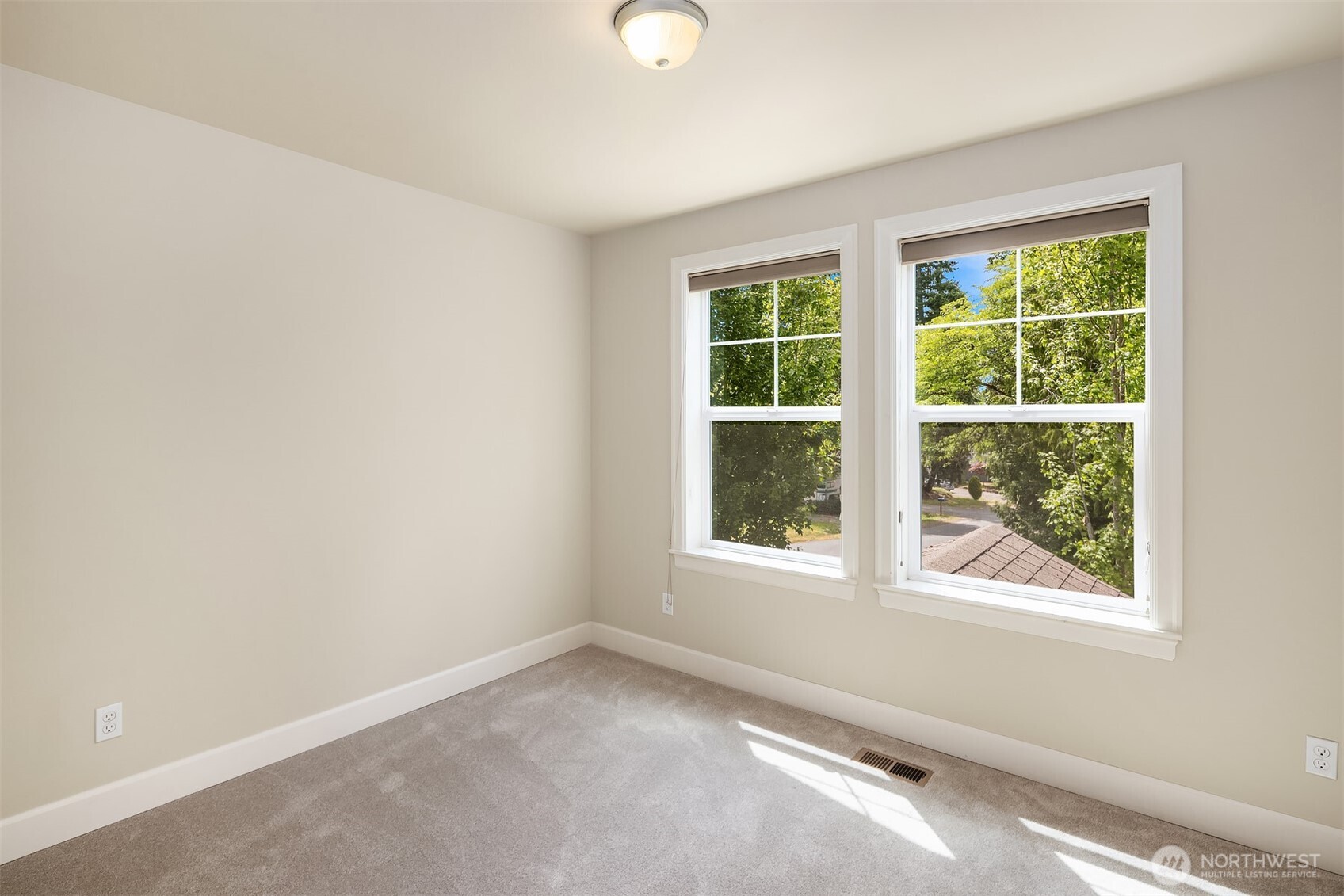 This light-filled bedroom on the upper floor is perfect for relaxing, resting, or spending time with family.
