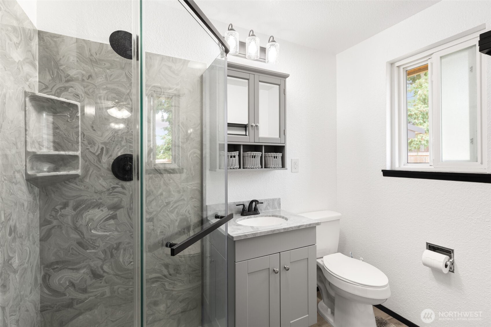 Primary bedroom quarter bathroom shower, vanity and toilet seat with window and storage