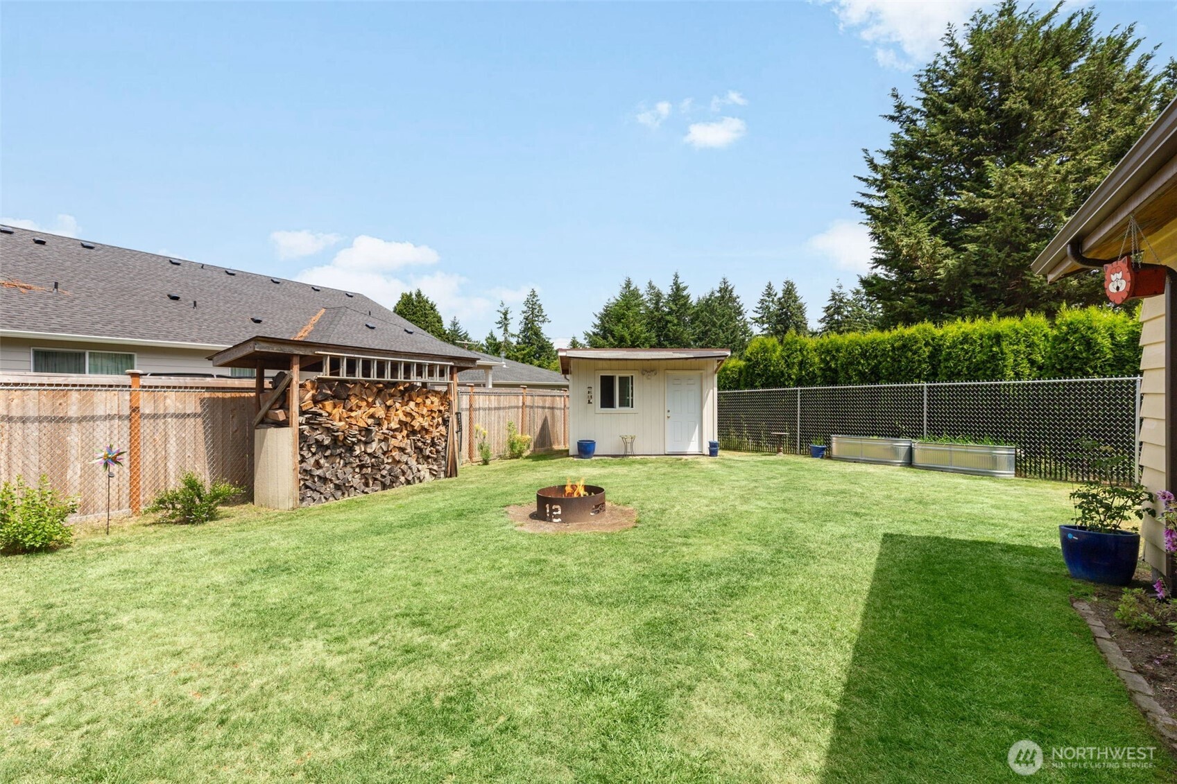Firepit and nice size storage shed including storage for wood