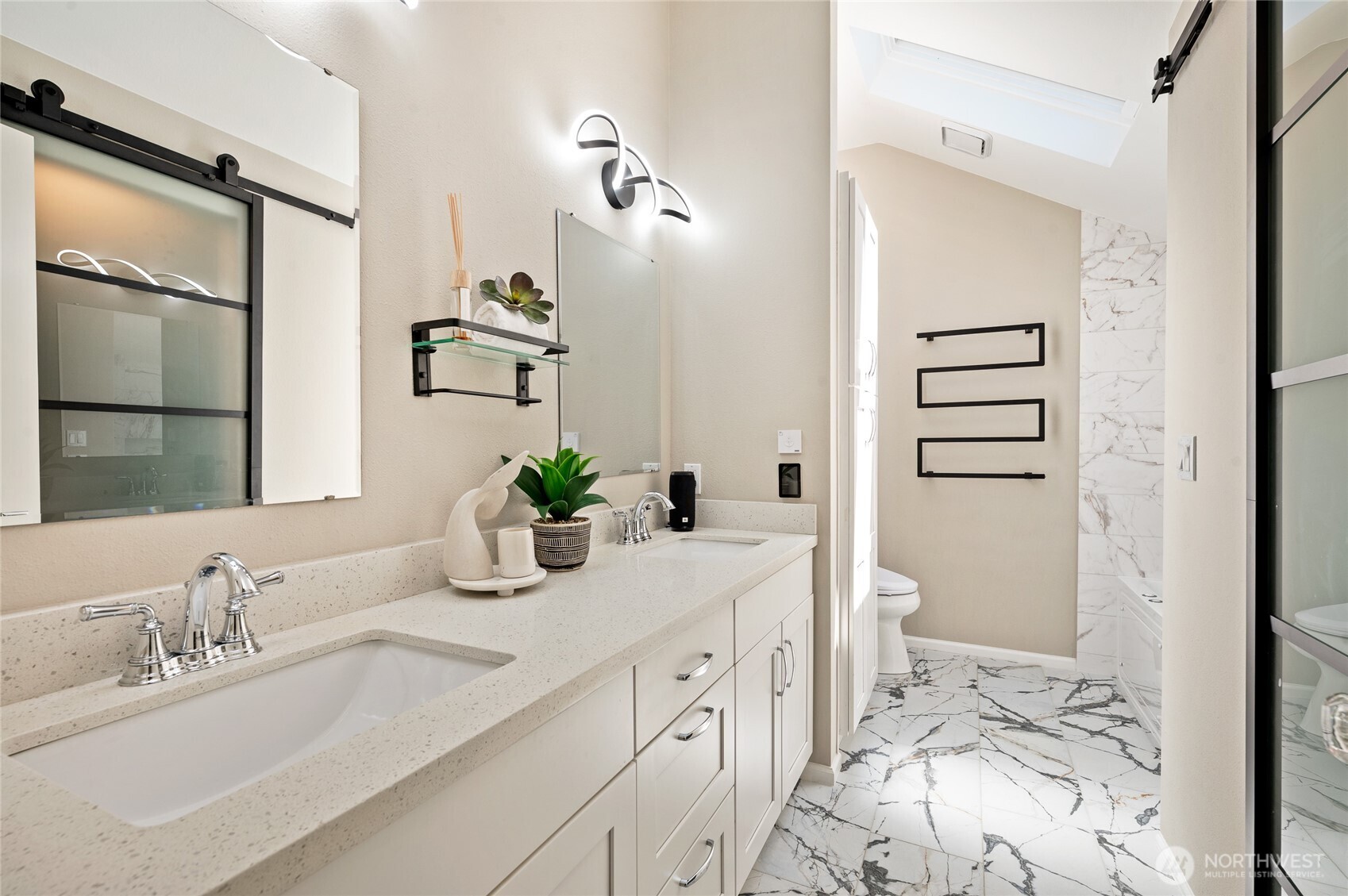 Brand-new spa inspired primary bath with heated floor and heated towel rack.