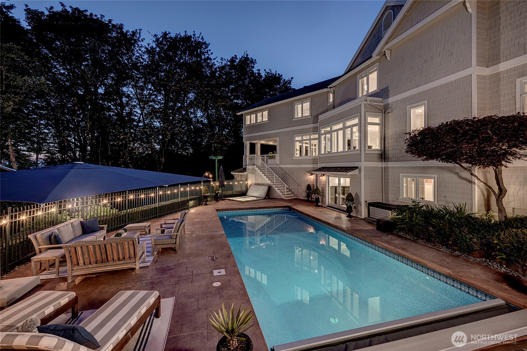 The expansive back patio offers a serene retreat with a sparkling pool and spa, perfect for relaxing or entertaining with complete privacy.