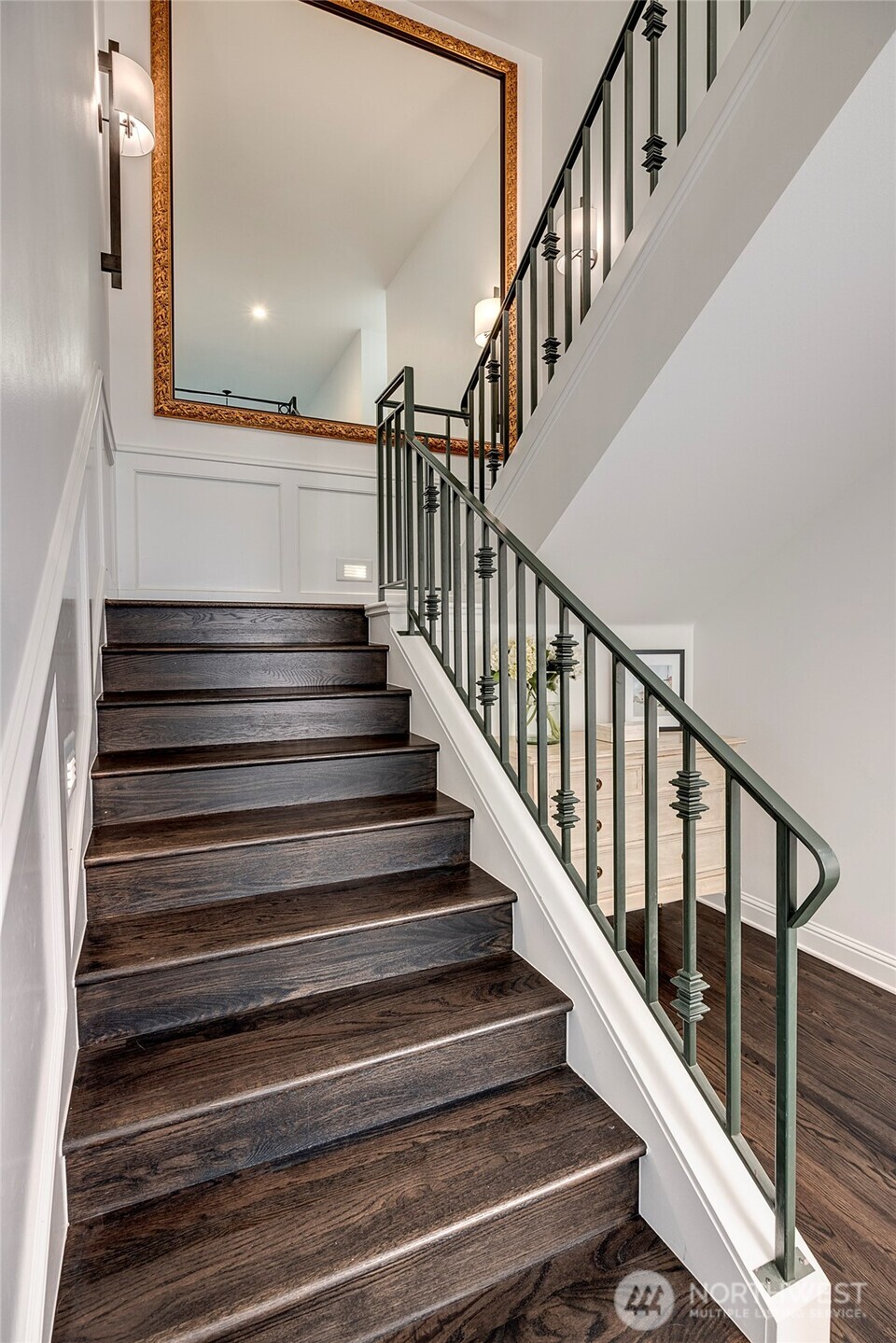 To the right of the foyer lies a picture perfect home office, situated in the base of the “bell tower”, with over a dozen windows, built-in bookshelf and a spiral staircase leading to the loft above.
