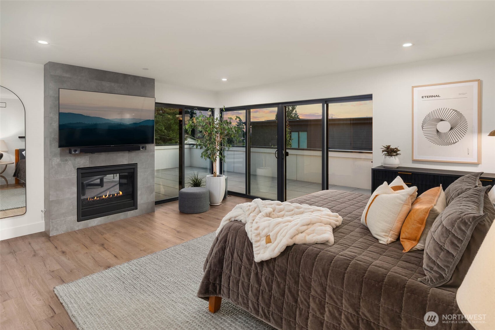 The primary suite is a serene retreat featuring private deck access.