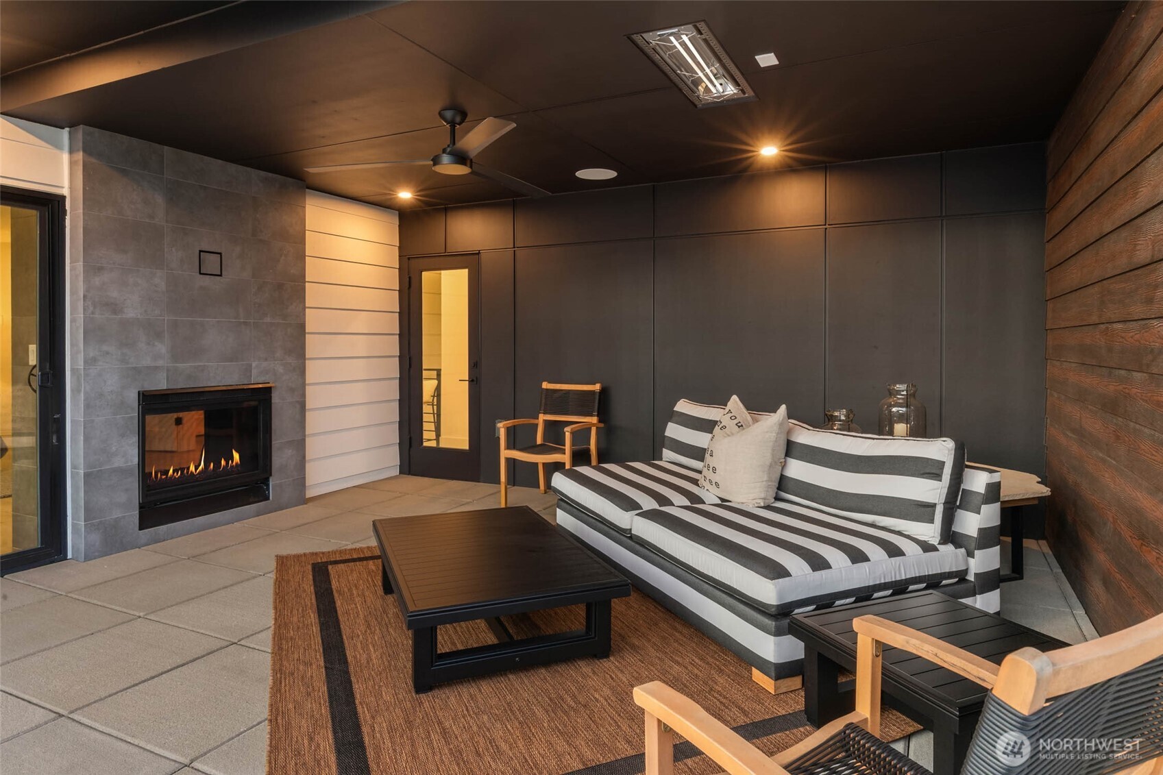 Deck of the primary with two-sided fireplace, and stunning views of Lake Washington and the Olympic Mountains.