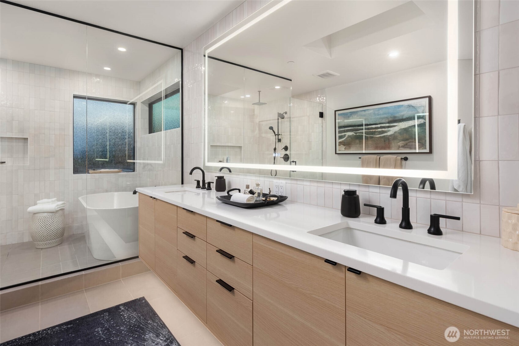 The spa-inspired ensuite bath offers a spacious wet room with dual showers and a soaking tub, heated floors, and an expansive walk-in closet with custom organizers and a discreet washer/dryer for ultimate convenience.