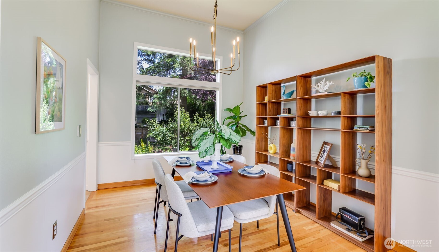 Tucked between the kitchen and entryway, this delightful dining area is bathed in natural light from a large window and offers a blank canvas to craft your own warm and welcoming gathering space