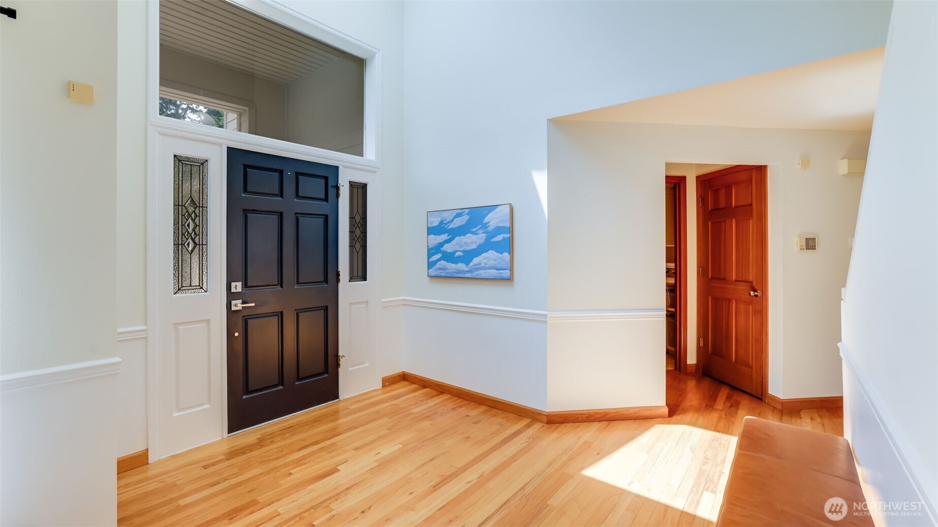 Beautiful soaring ceilings and a grand window above the front door fill the entryway with natural light and a sense of openness