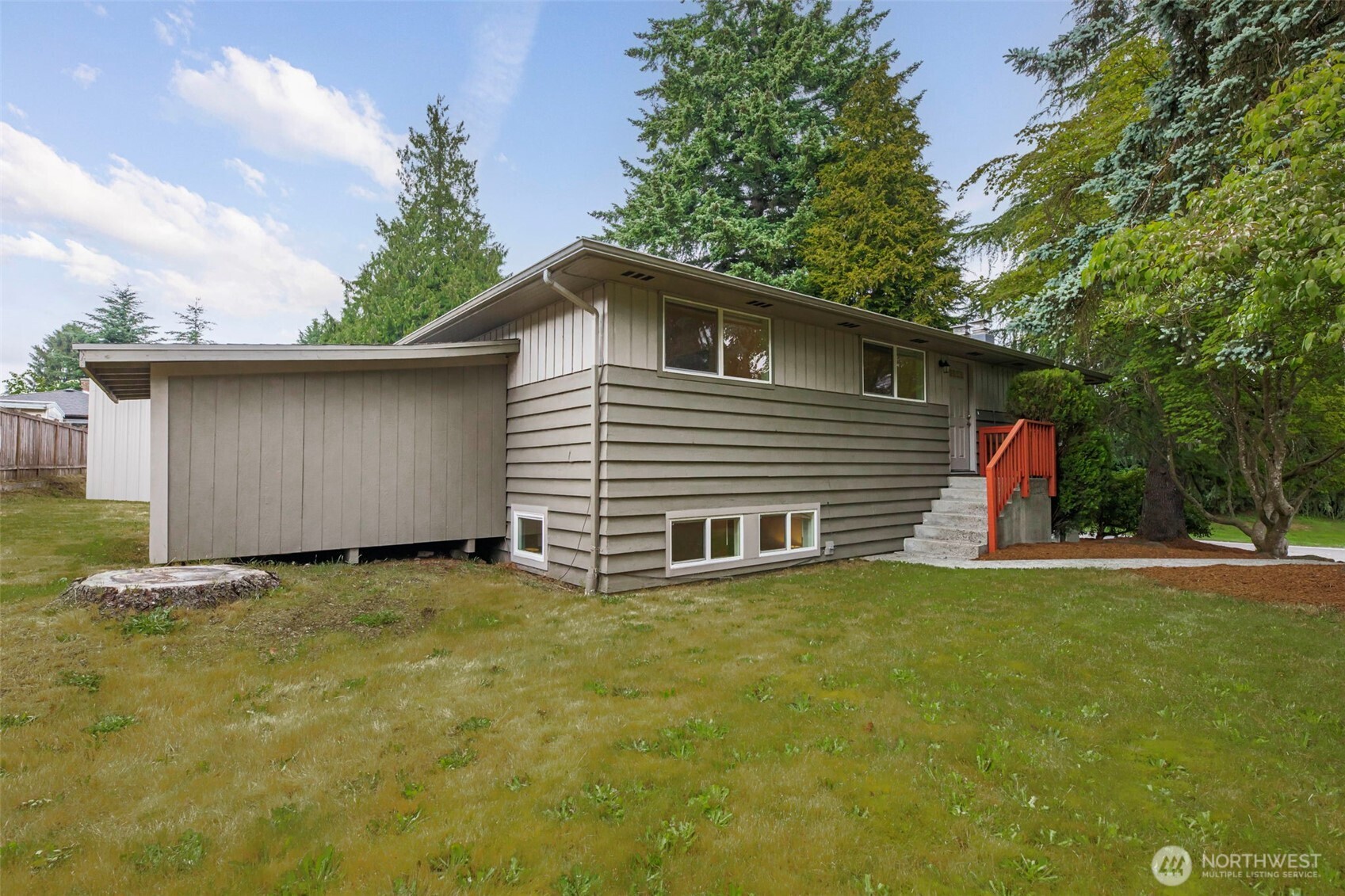 Front of house w/ storage shed.