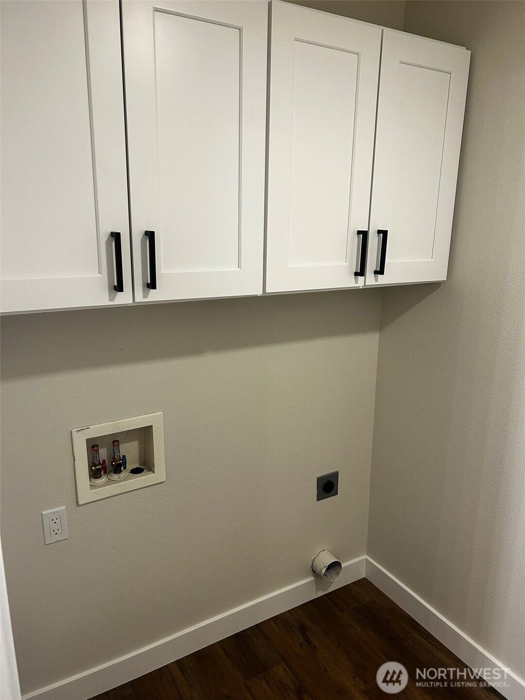 Full sized laundry room with cabinets