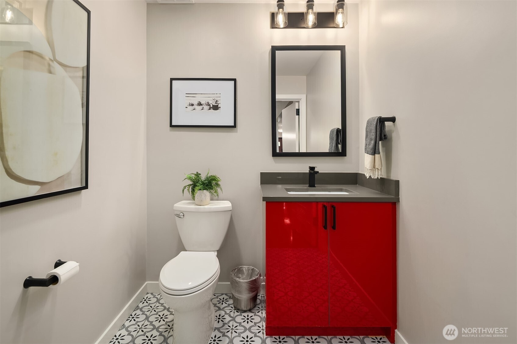 A little firehouse flair—this bold powder room adds just the right spark.