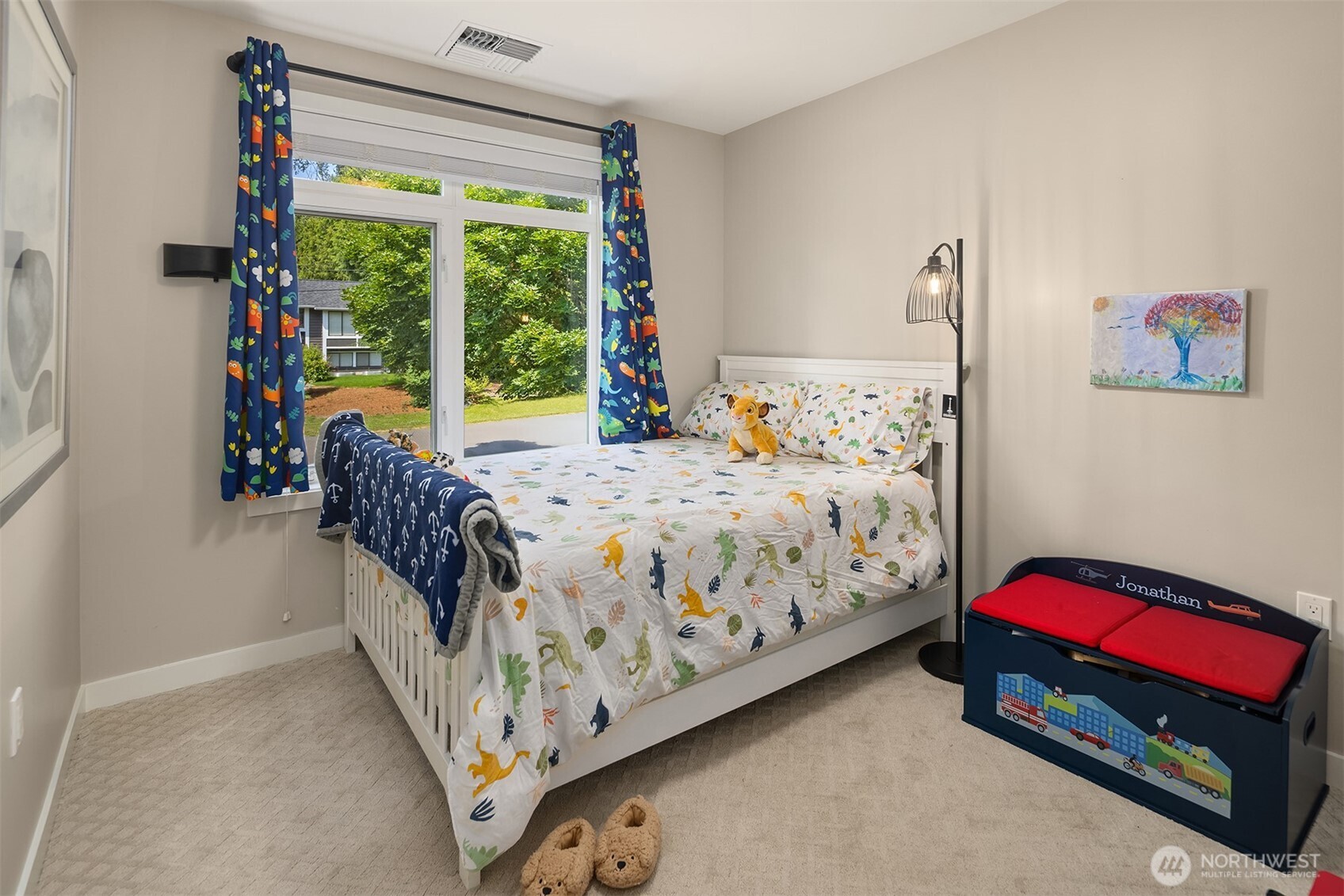 Bright and inviting bedroom with large window and playful charm—perfect for little dreamers.