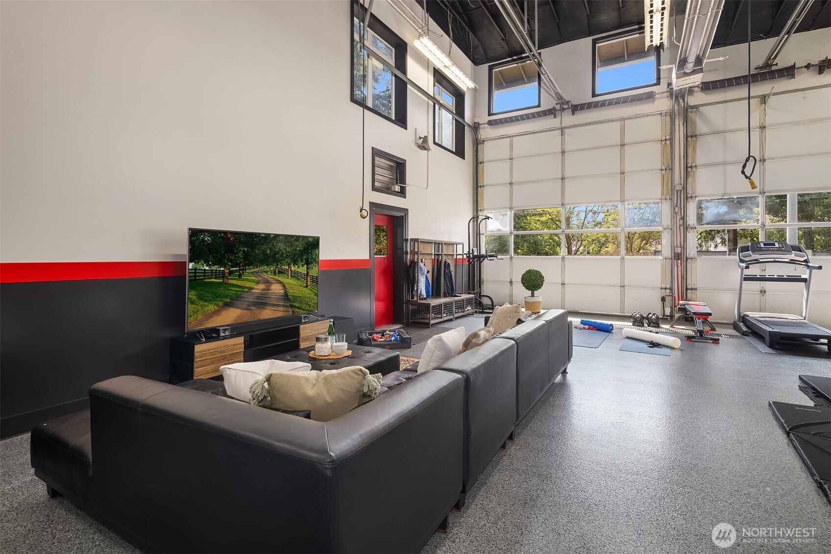 The Ultimate Flex Space: Our Cavernous Garage! This isn't just a garage; it's an incredible, heated, and insulated recreation haven. We've transformed the former fire truck and ambulance bays into an expansive rec room with a TV zone for adults and a fantastic play area for our two young children.