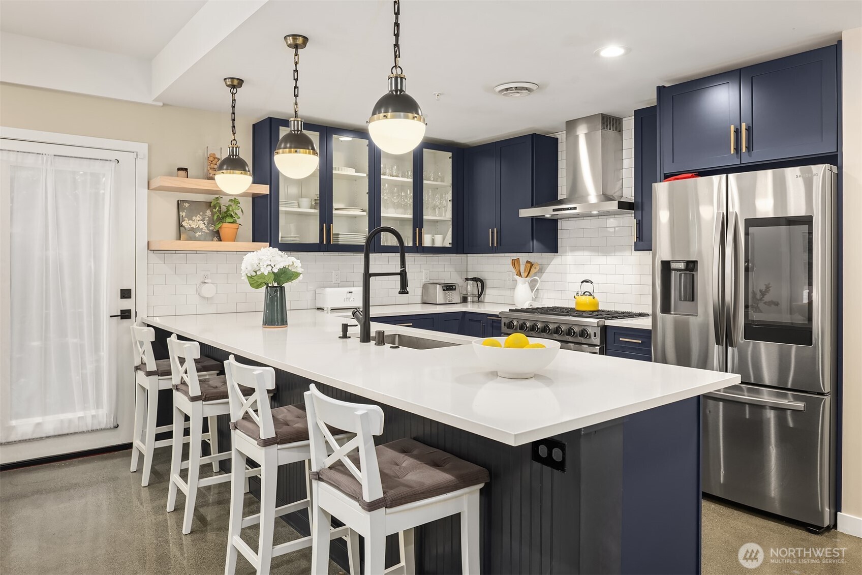 Bright, bold, and beautifully redone—fresh cabinetry and quartz counters elevate the space.