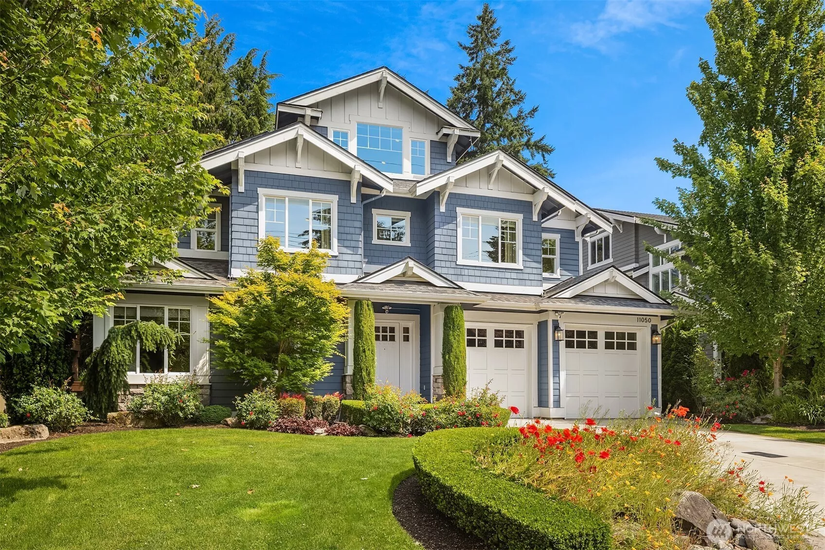 From the crisp blue facade to the vibrant landscaping, this Enatai stunner checks every box before you even step inside.