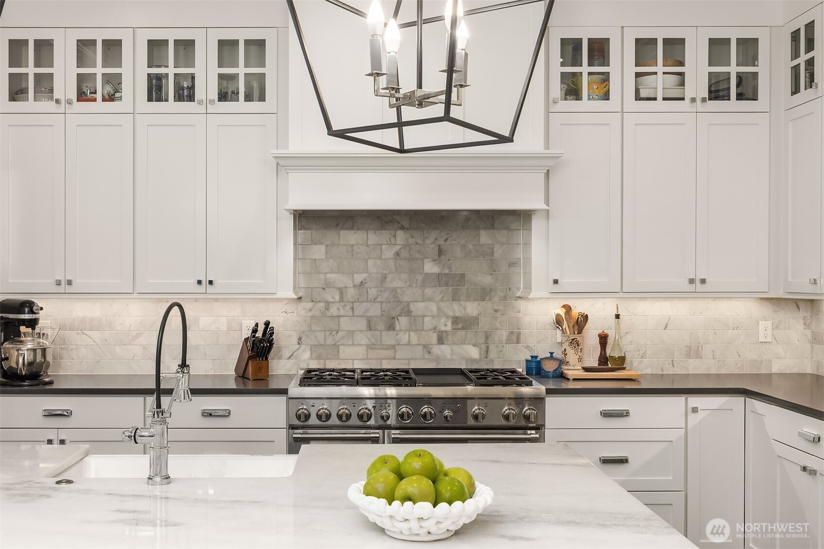 Every great meal starts with a space that inspires—and this one delivers. From the gleaming pro range to the custom hood and timeless marble backsplash, this kitchen is equal parts showpiece and workhorse. Just add a chef (or a DoorDash account—we won’t judge).