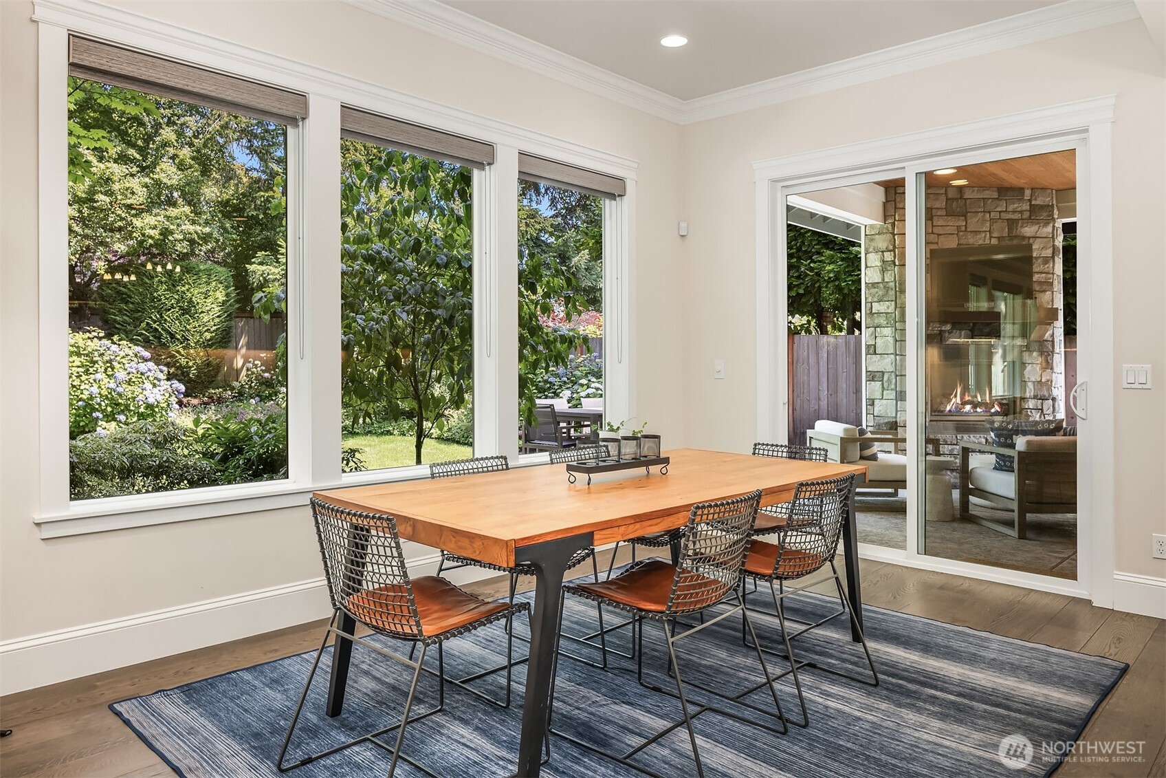 Sun-drenched breakfast nook with garden views by day, cozy fireside dinners by night—this indoor-outdoor connection serves up ambiance on demand.