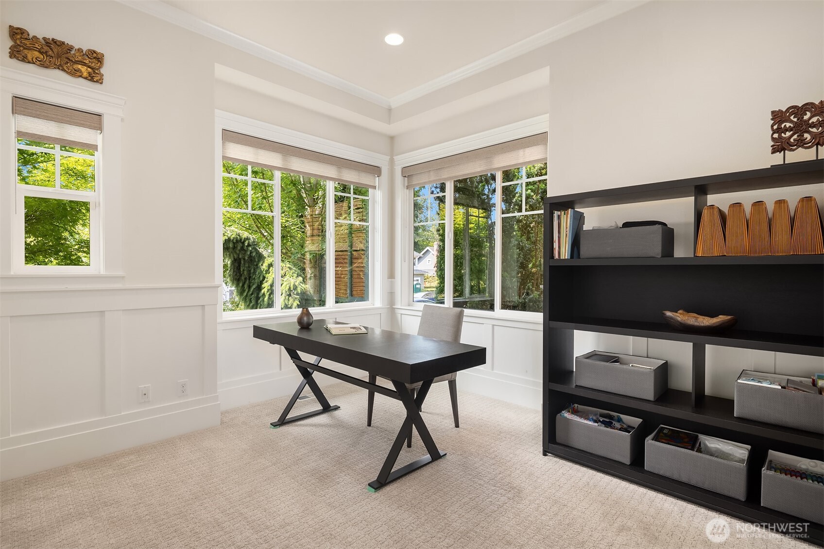 Flexible main floor space with corner windows and elegant millwork—ideal as a sunlit home office or easily converted into a main-level bedroom to suit your needs.