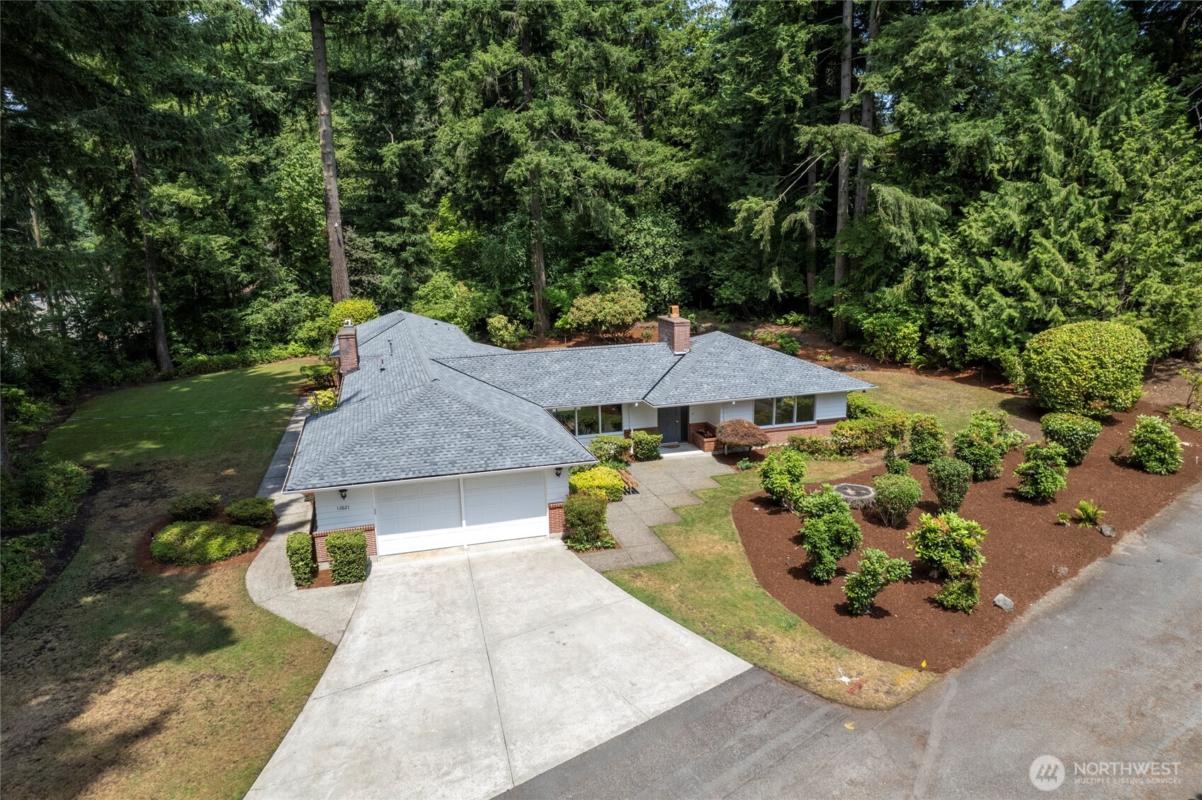 Drone shot of this wonderful home showing beautiful landscaping.New roof with transferable warranty to new owner.New paint both in and out.