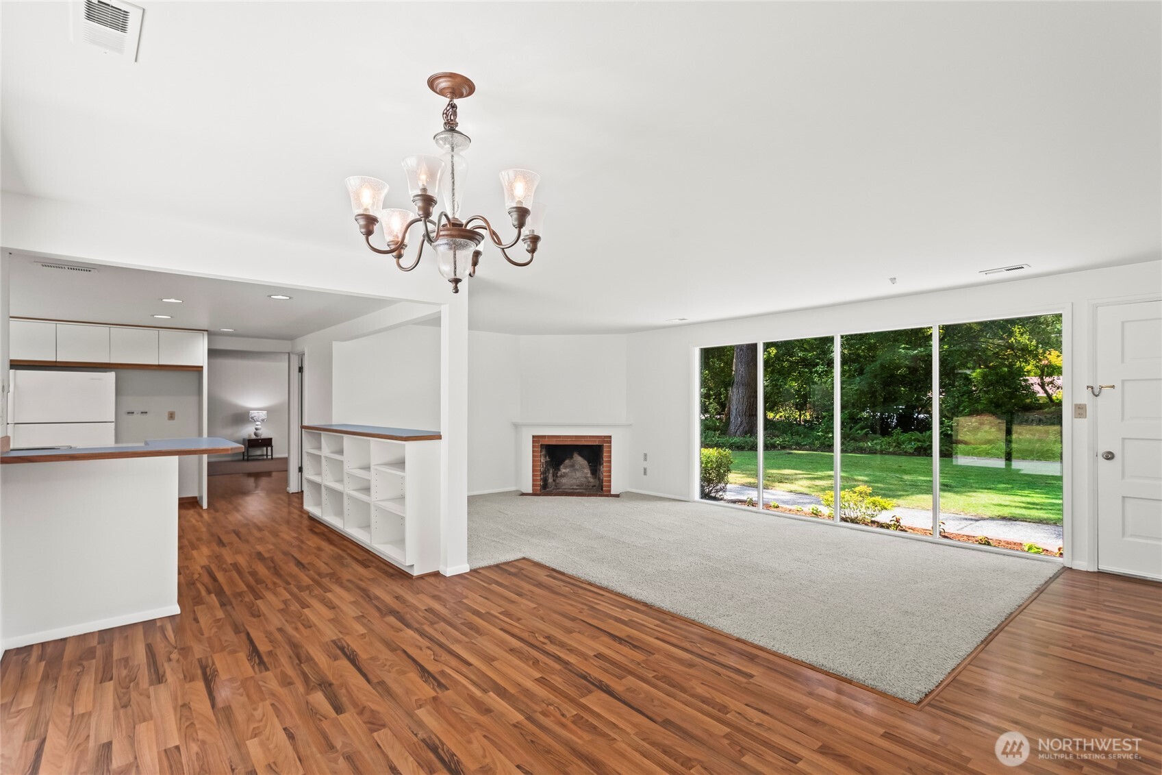 View from dining room looking into Family room.wood burning fireplace currently but can easily be converted to gas.Gas stub is right outside.