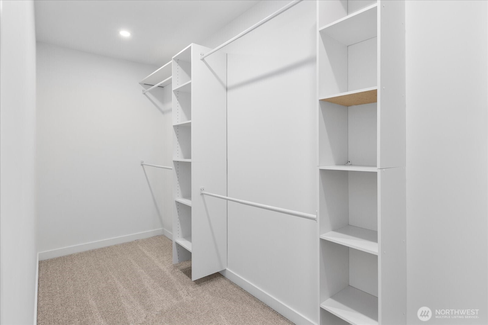 Huge walk in closet with built in cabinets.