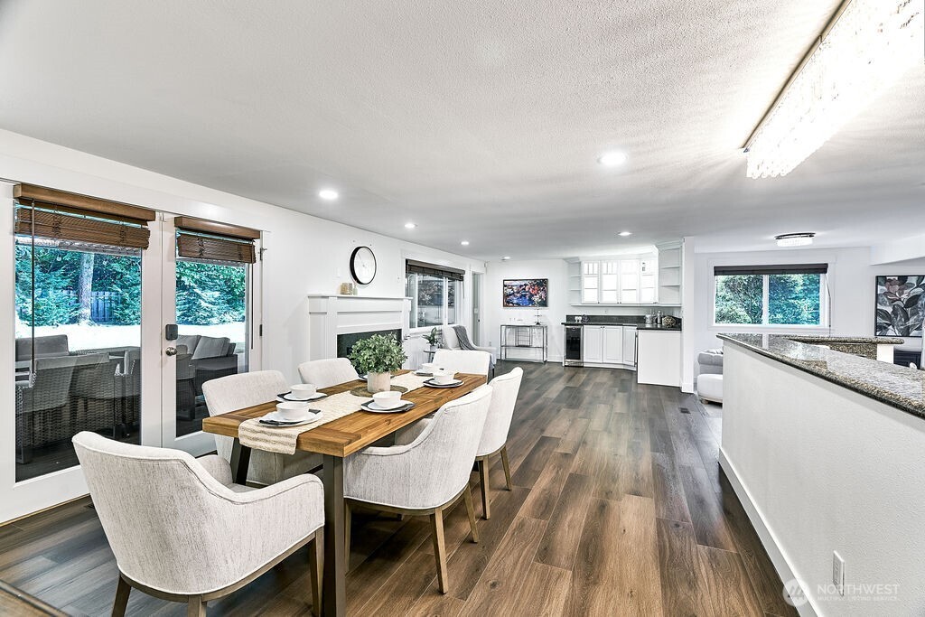 Dining room with doors leading out to a covered patio with built in heaters for year-round dining and entertainment