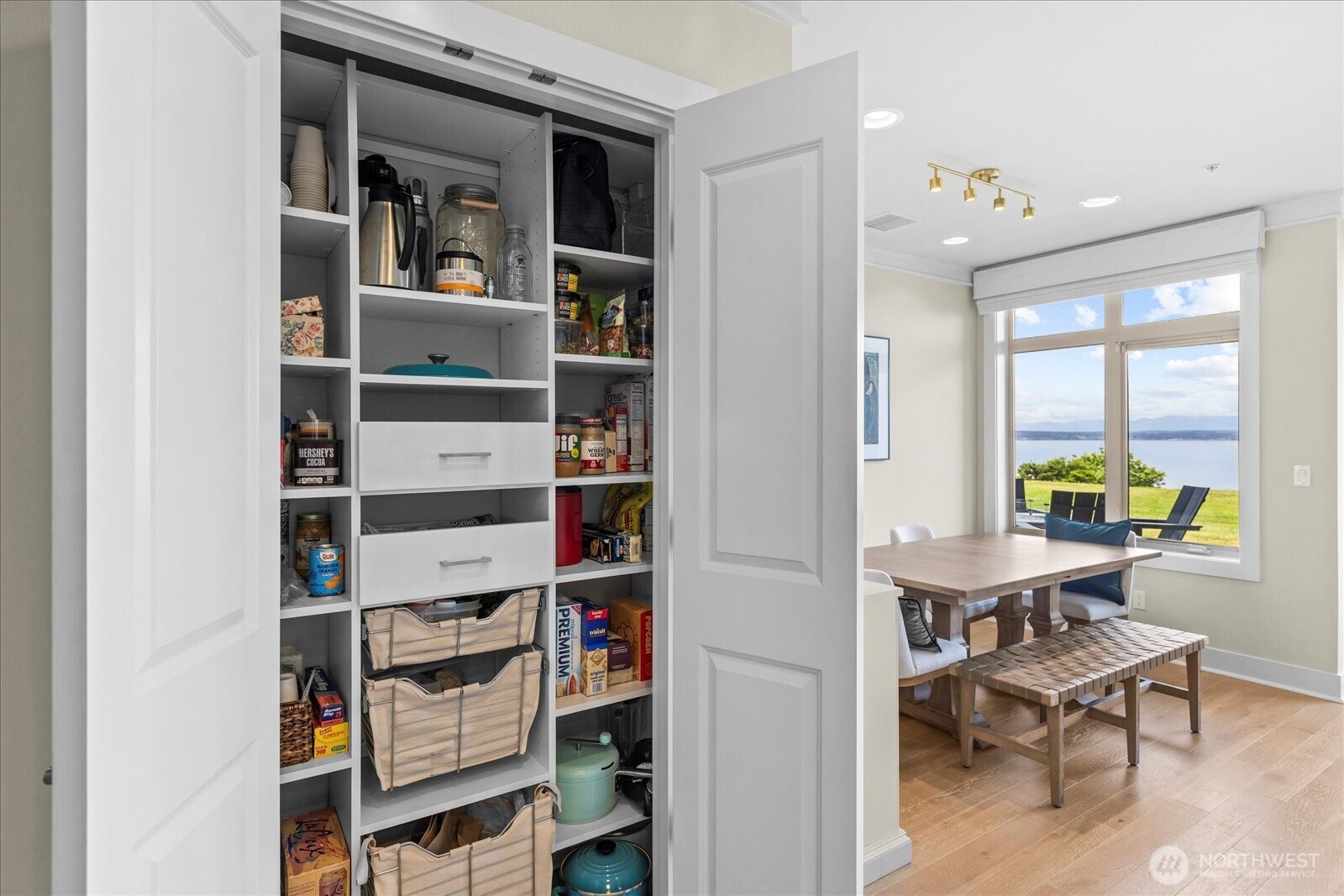. . . Custom 'reach in' pantry is practical but pretty, behind double doors.
