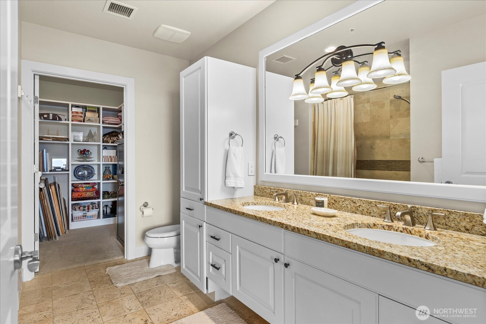 Walk-in closet at the back of the bath stores a