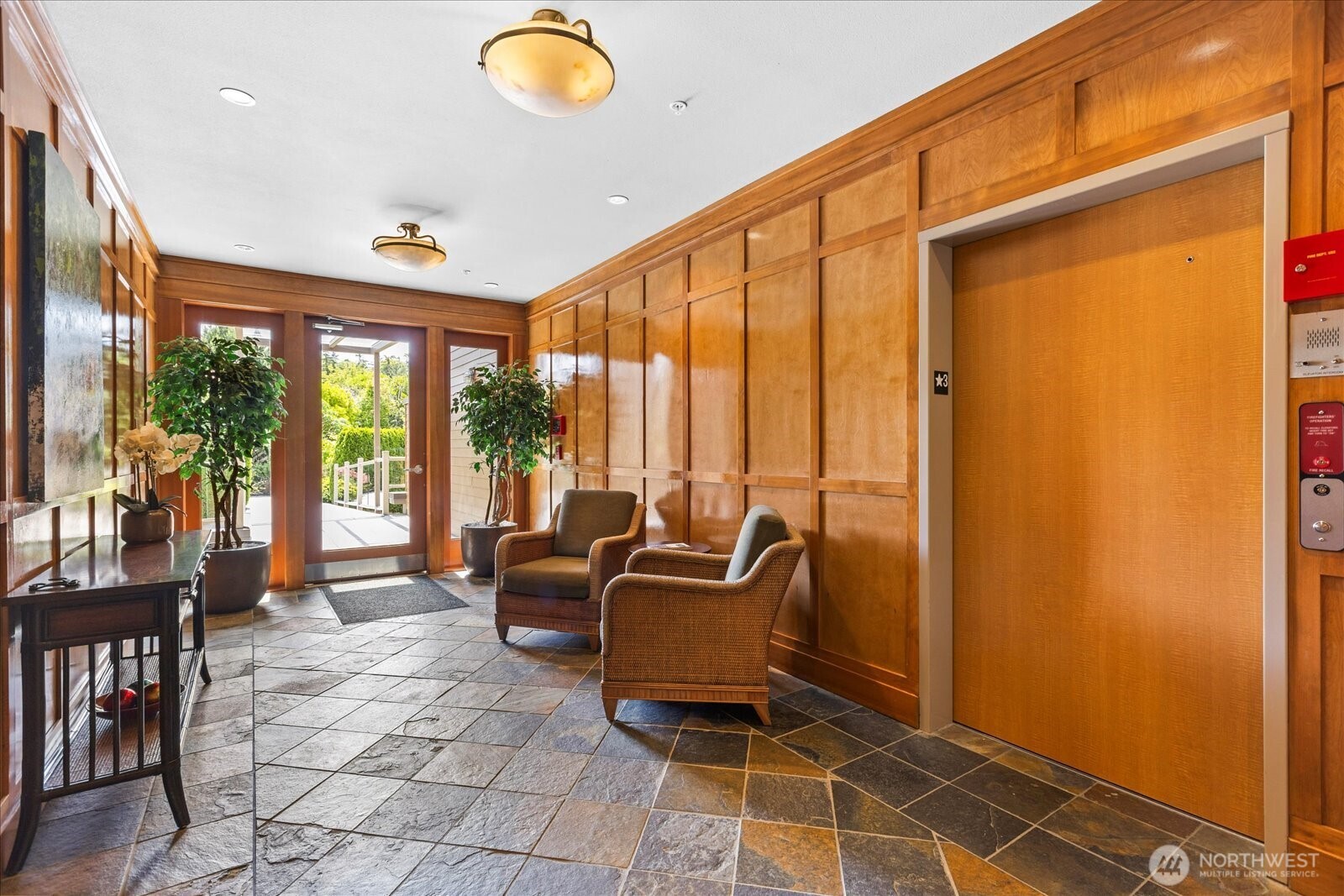 Paneled wood lobby with slate flooring welcomes you in . . .