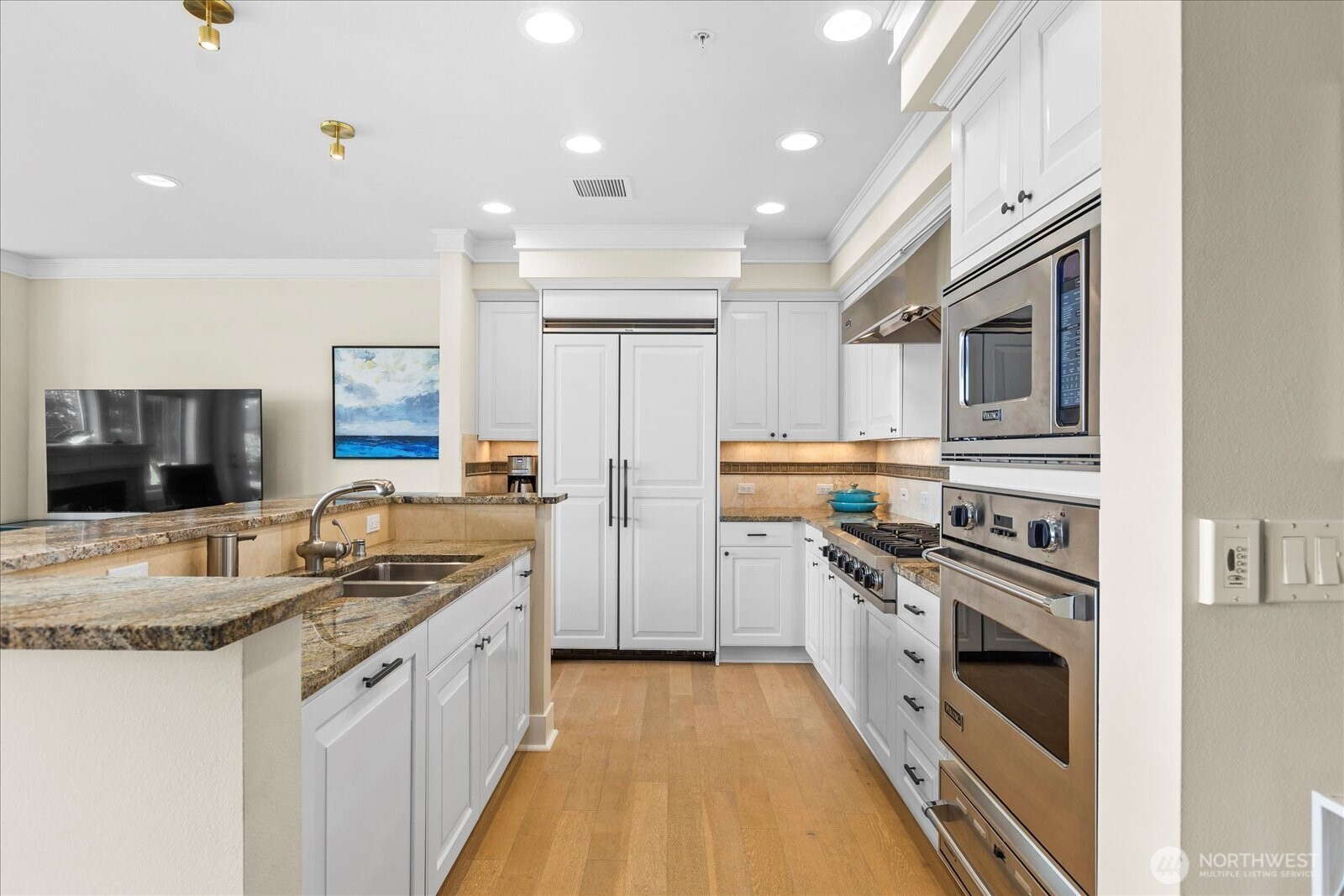 Wonderful Chef's kitchen with slab granite counters, newly painted cabinetry,wide-plank hardwood flooring and travertine tile . .