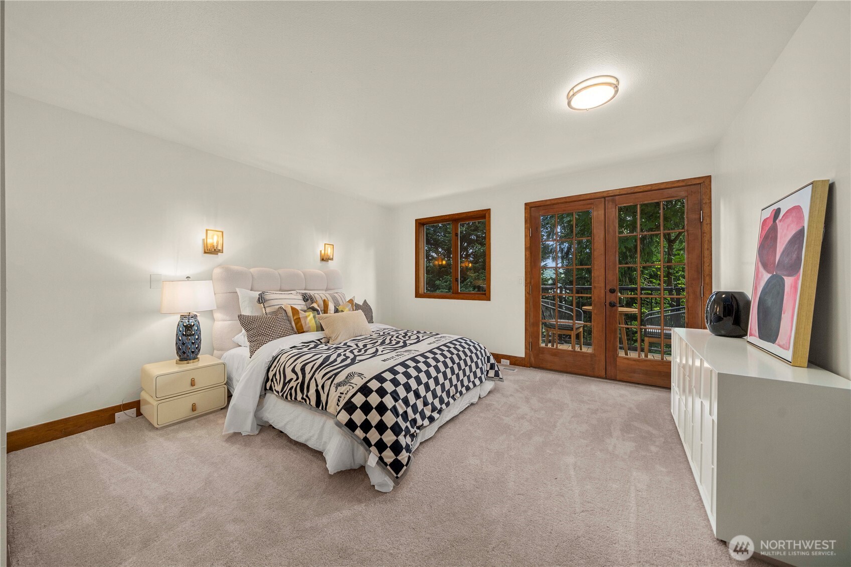 A bedroom suite on upper level with a private deck